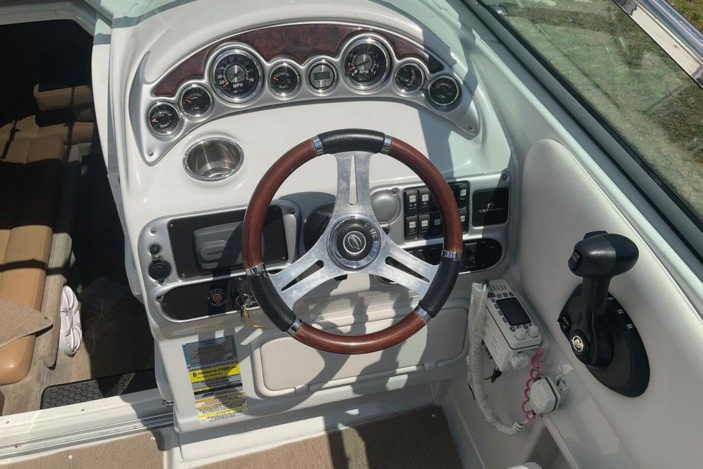 2015 Crownline 236 SC boat dashboard with steering wheel and control panel.