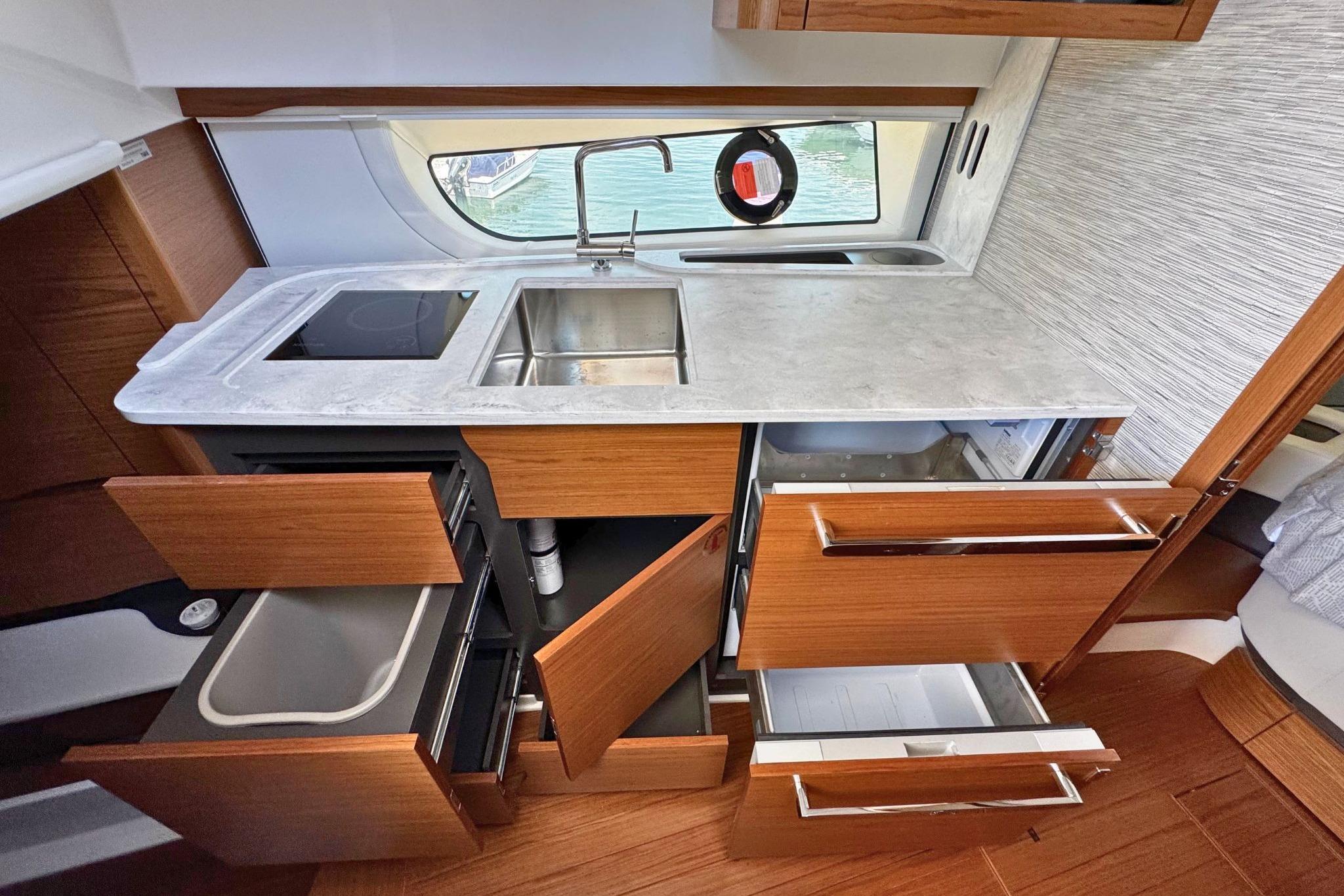 Modern kitchen interior of 2027 Tiara Yachts 39 LE with open cabinets and sleek design.