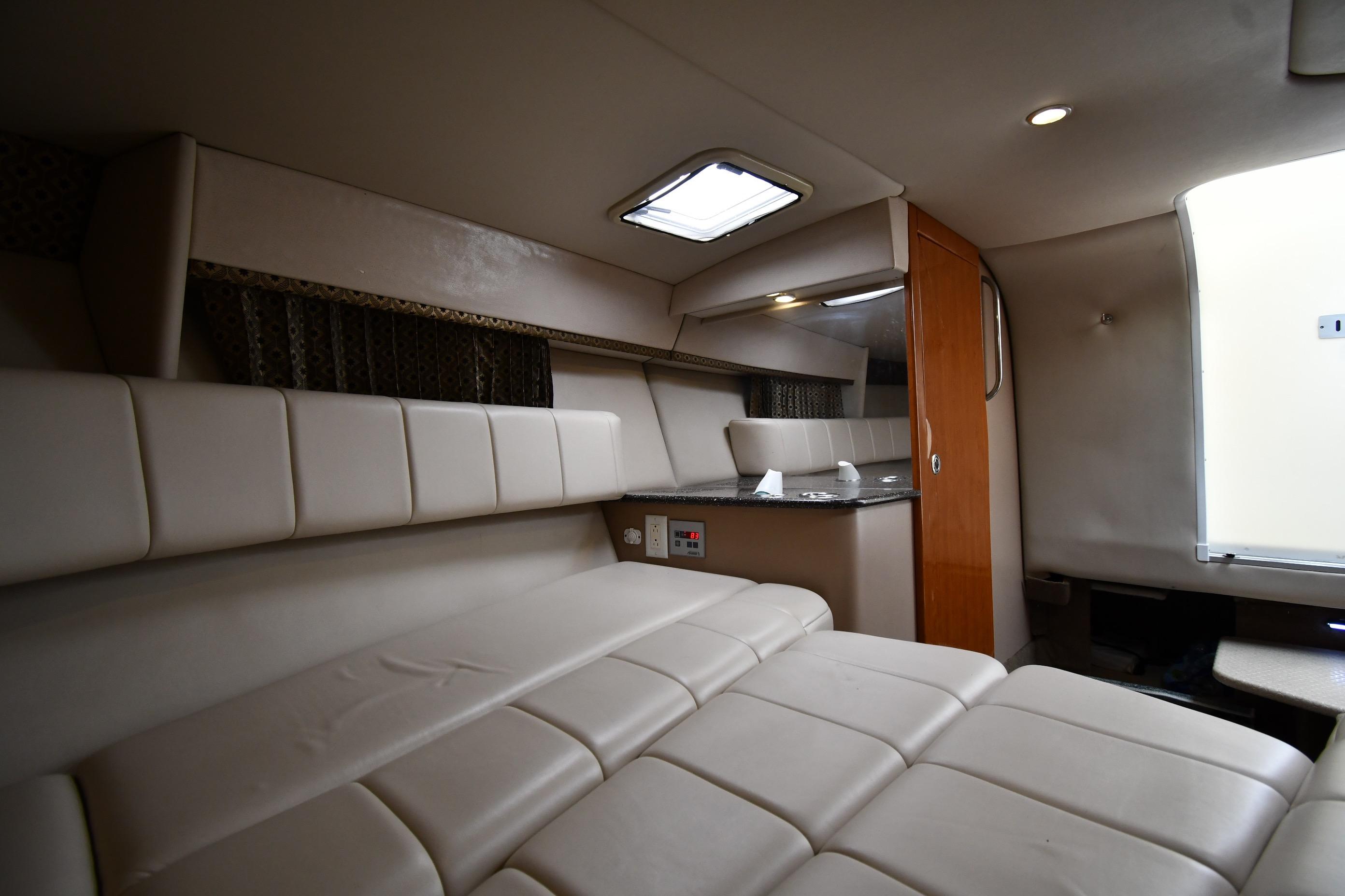 Interior of 2004 Formula 330 Sun Sport boat with beige seating and compact kitchenette.