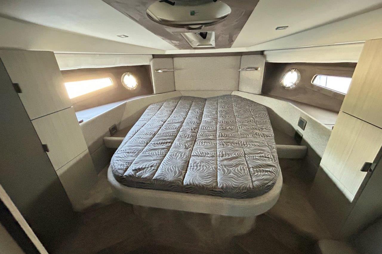 Luxurious cabin interior of 2025 Cranchi M44HT yacht with elegant bedding.