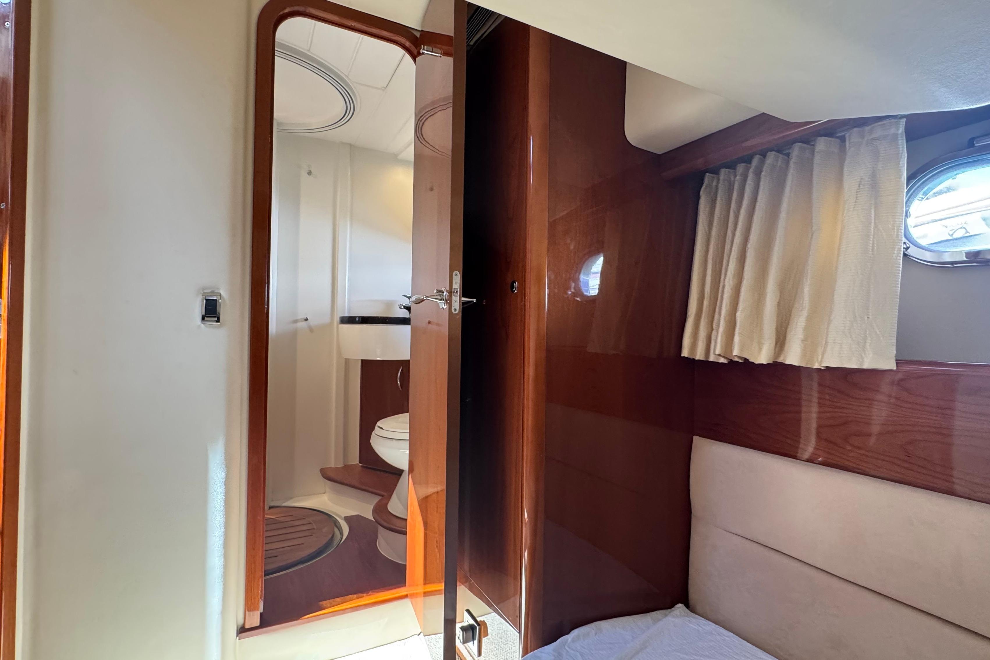 Interior of 2006 Princess 42 Flybridge Motor Yacht with bathroom and wooden finishes.