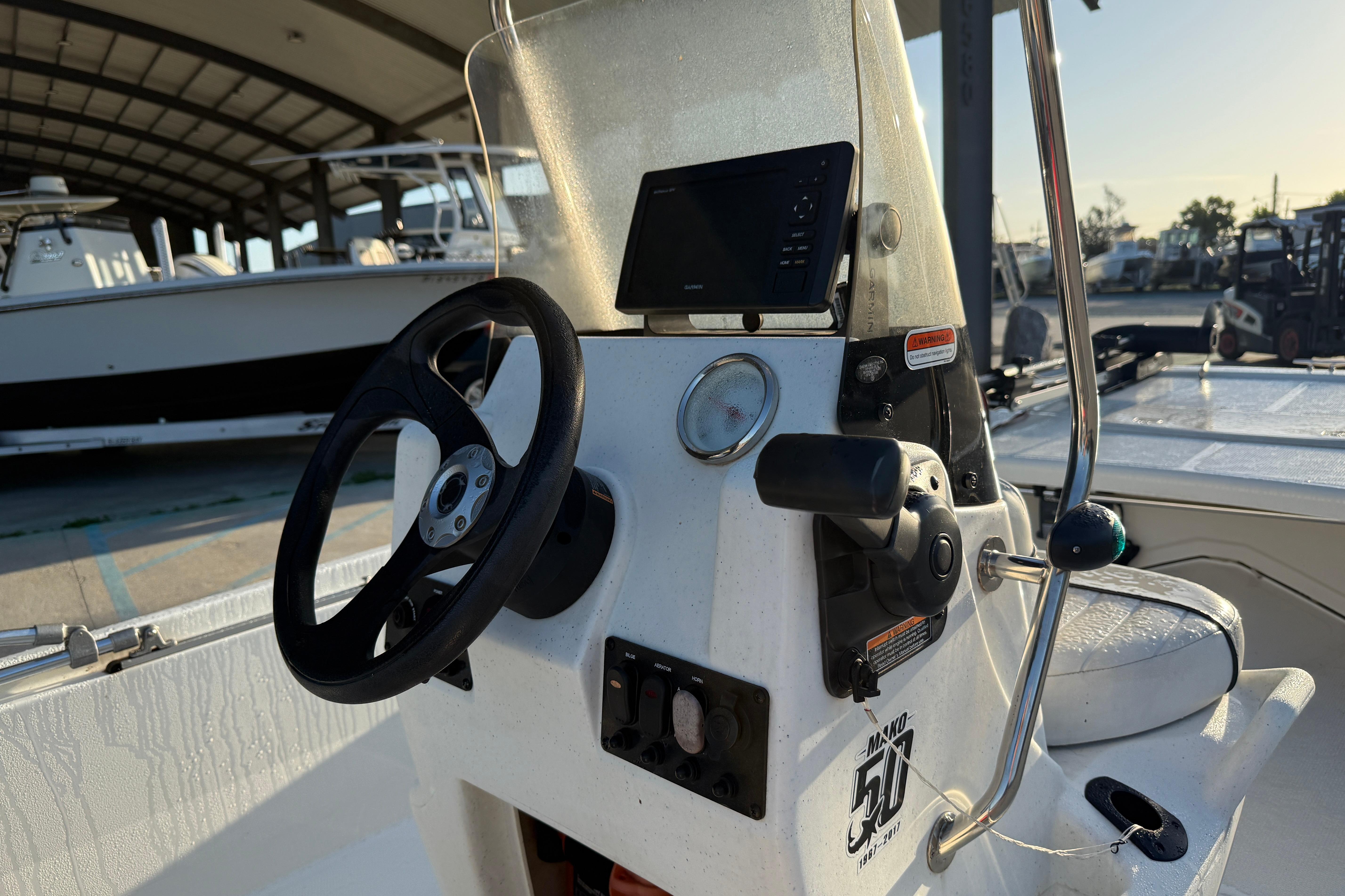 2017 Mako Pro Skiff 17 CC boat console with steering wheel and controls.