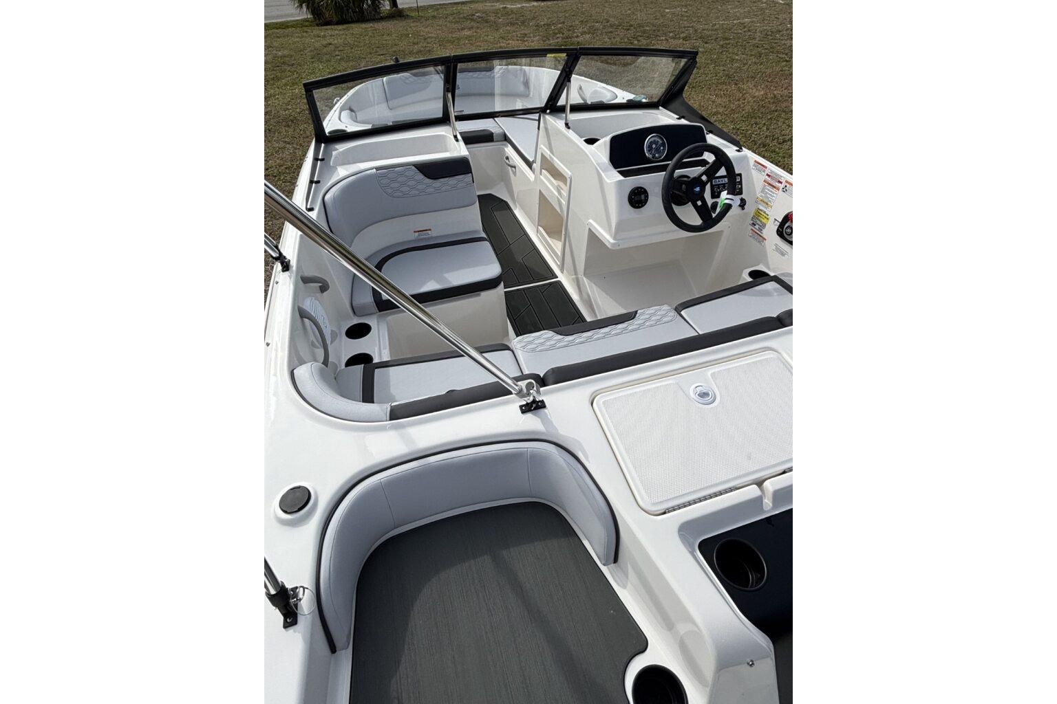 2025 Bayliner Element M17 boat interior with modern seating and steering console.