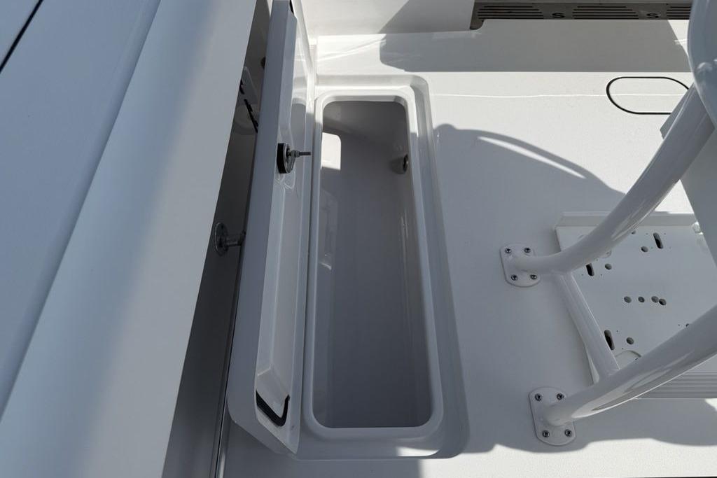 2026 Sportsman Open 252 Center Console boat storage compartment, open and empty.
