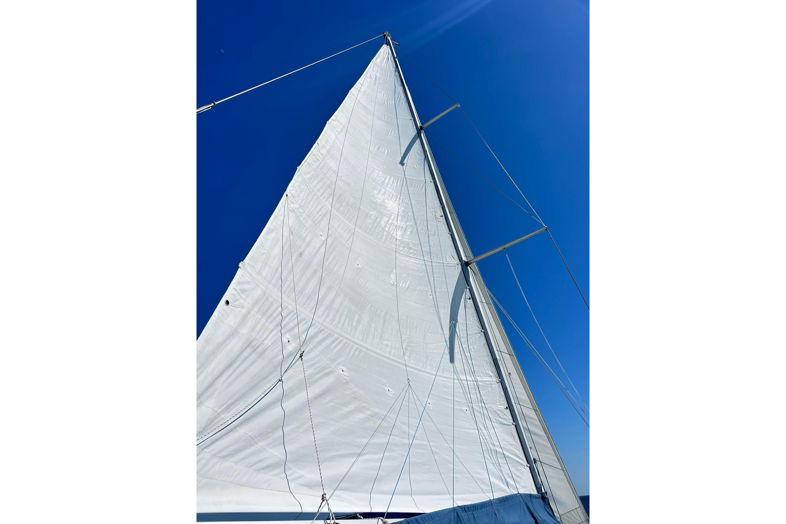 Sail of 1987 Gulfstar CSY 50 Pilot House against clear blue sky.