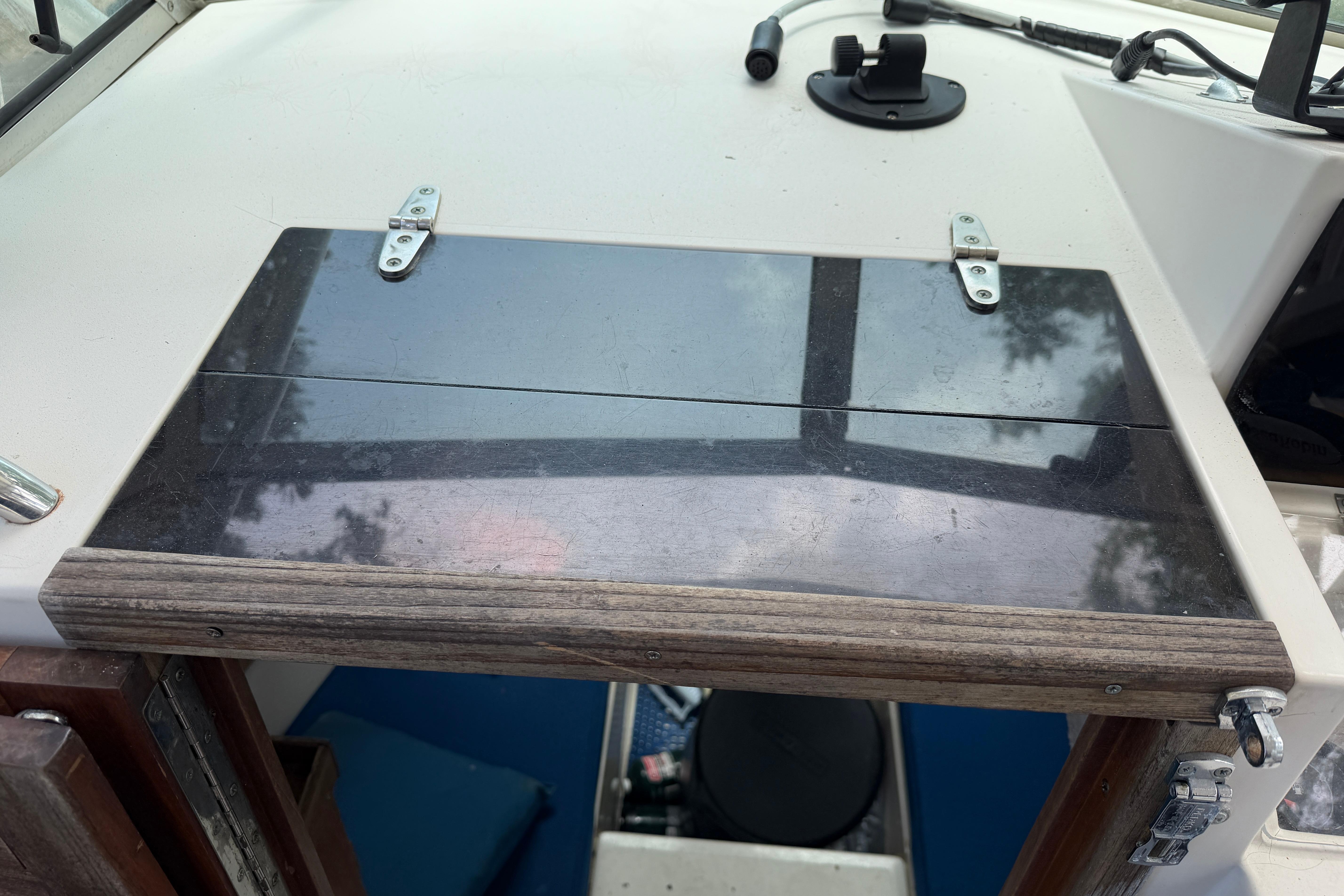 1987 Grady-White Seafarer 226 cabin entrance with wooden hatch and metal hinges.