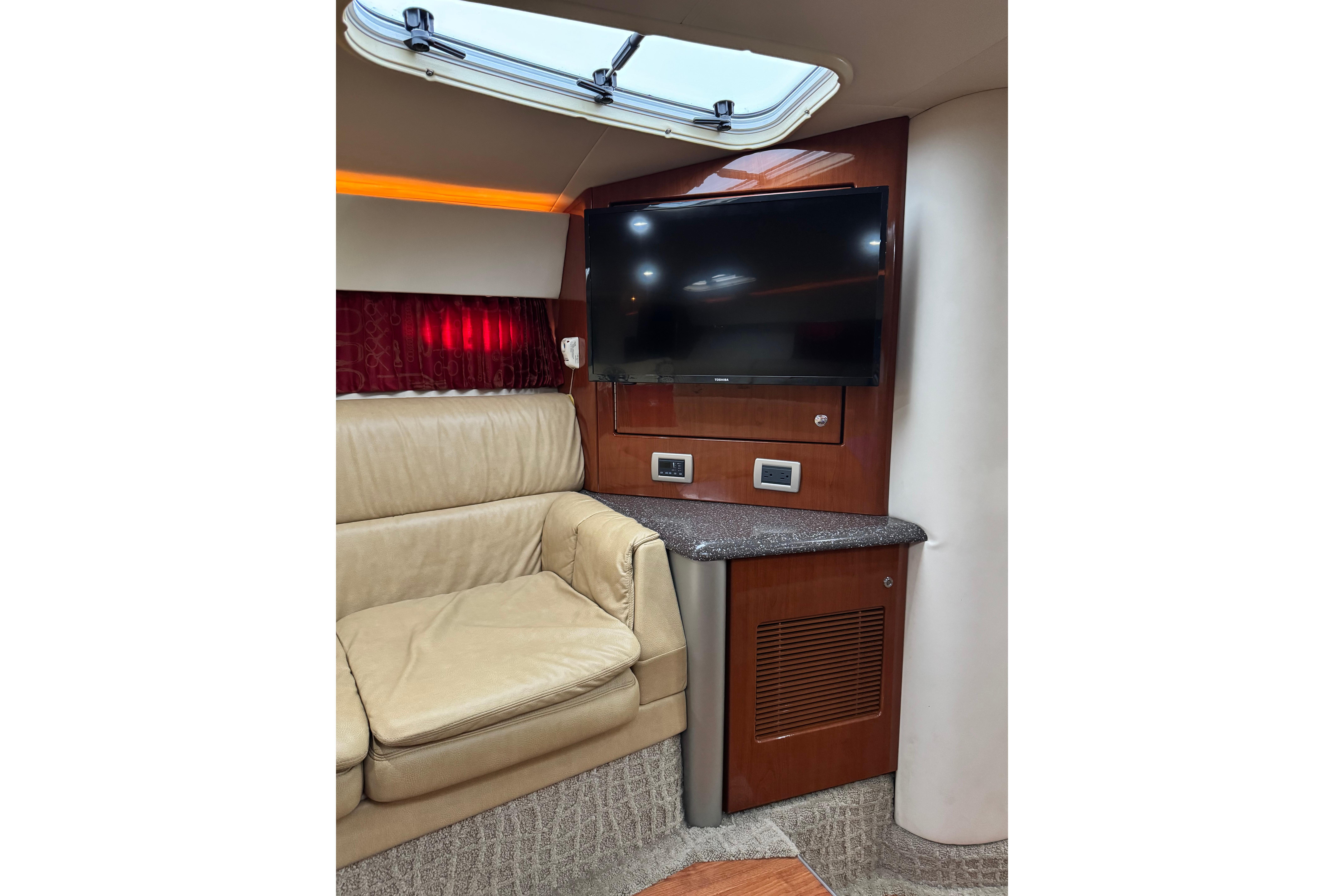 Interior of 2008 Formula 400 Super Sport yacht with leather seating and mounted TV.