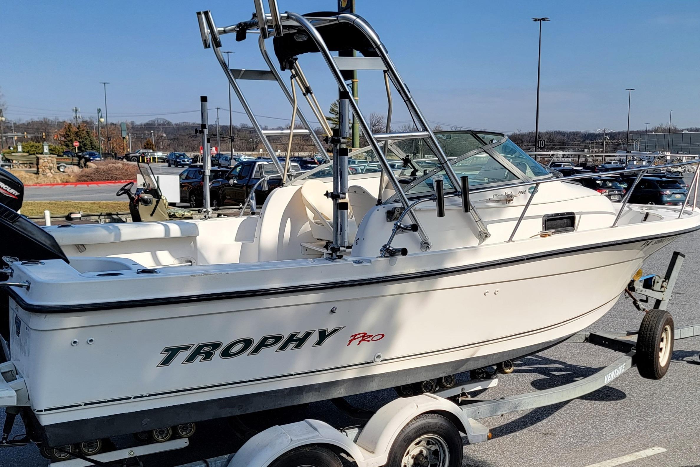 2003 Trophy 2002 Walkaround boat on trailer in parking lot.