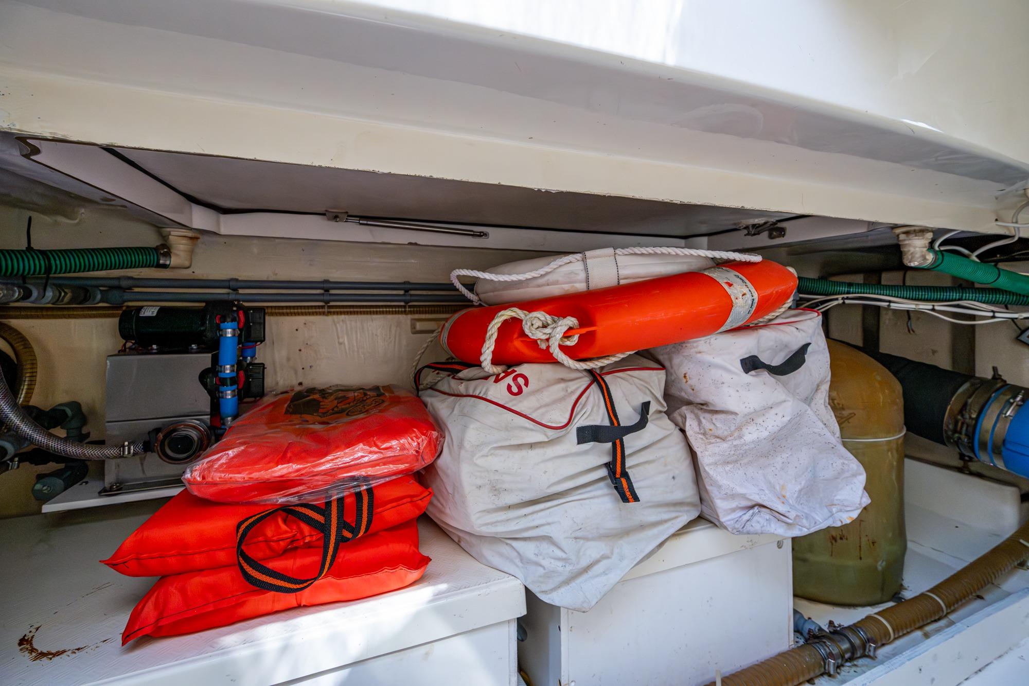 Storage area on 2000 Fairline Squadron 52 yacht with life jackets and safety equipment.