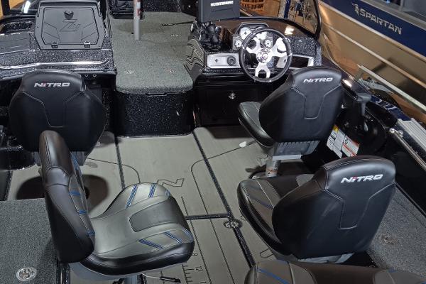 Interior of 2025 Nitro ZV20 boat with four black seats and modern dashboard.