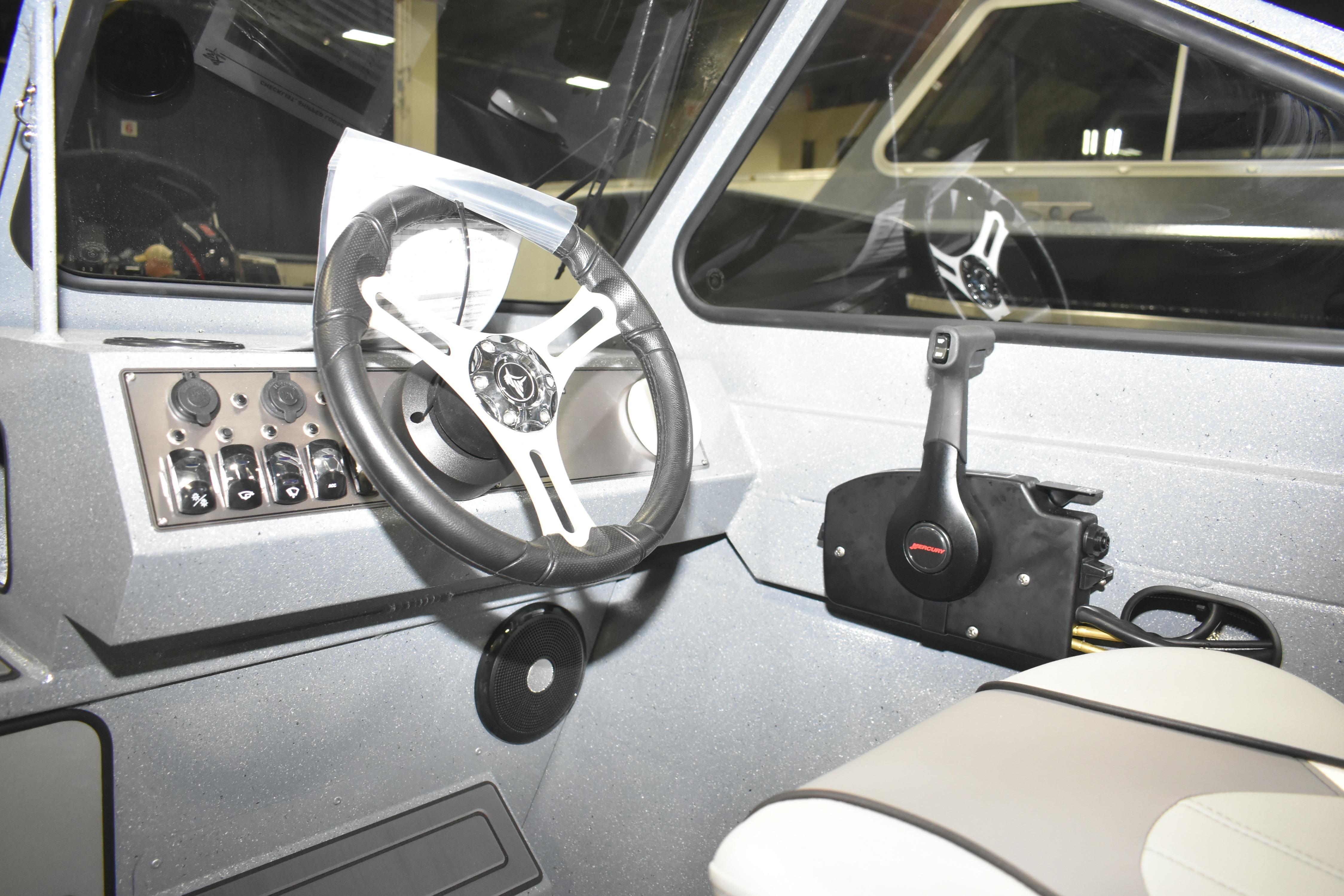 Interior of 2026 KingFisher 1825 Falcon boat with steering wheel and controls.