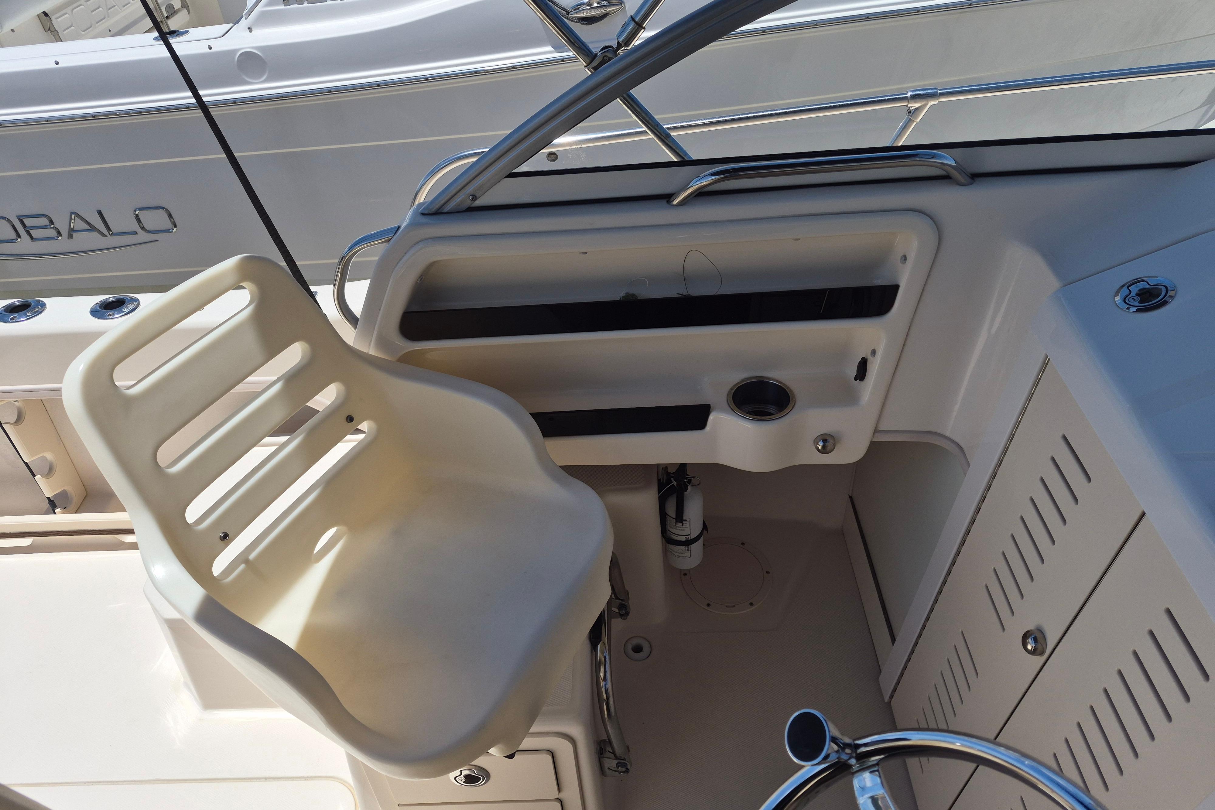 2022 Grady-White Adventure 208 boat helm with white captain's chair and steering wheel.