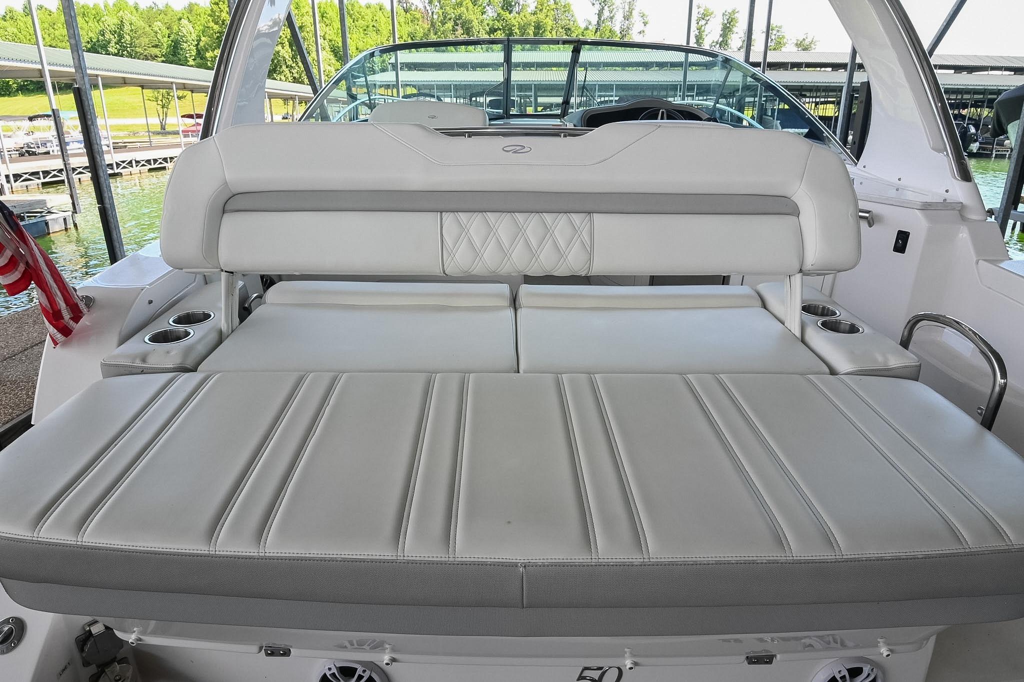 2021 Regal 33 Express boat interior with luxurious white seating and cup holders.