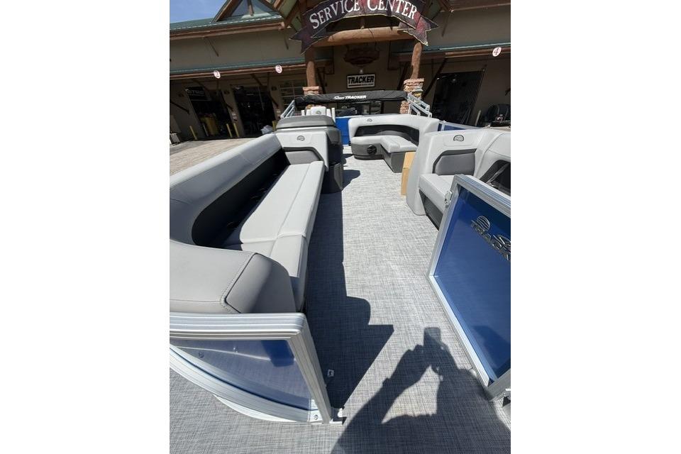 2026 Sun Tracker Party Barge 18 DLX interior with spacious seating at service center.