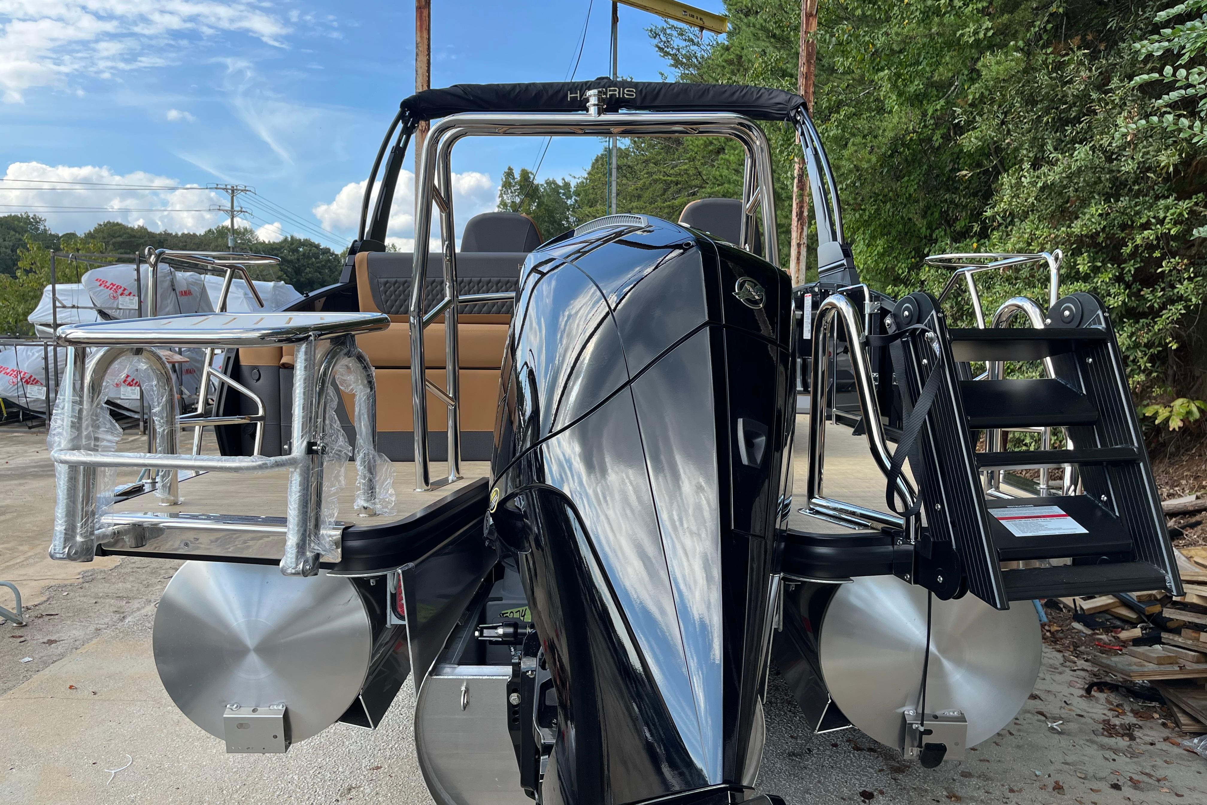2025 Harris Sunliner 250 pontoon boat with sleek black exterior and modern design.