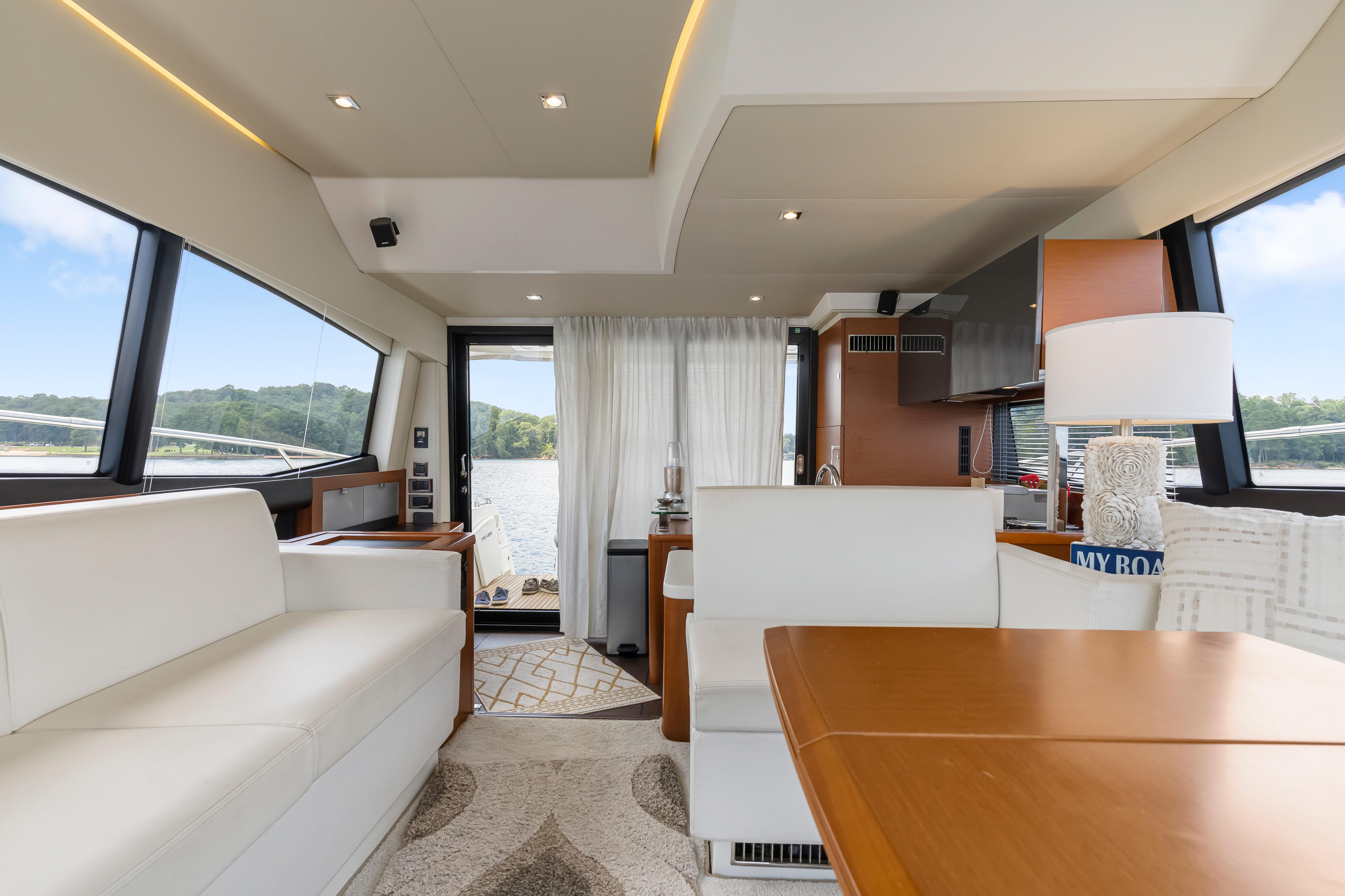 Luxurious interior of a 2017 Prestige 500 yacht with elegant furnishings and scenic views.