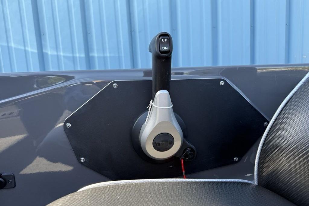 Throttle control lever on a 2026 Skeeter ZX150 boat, against a blue background.