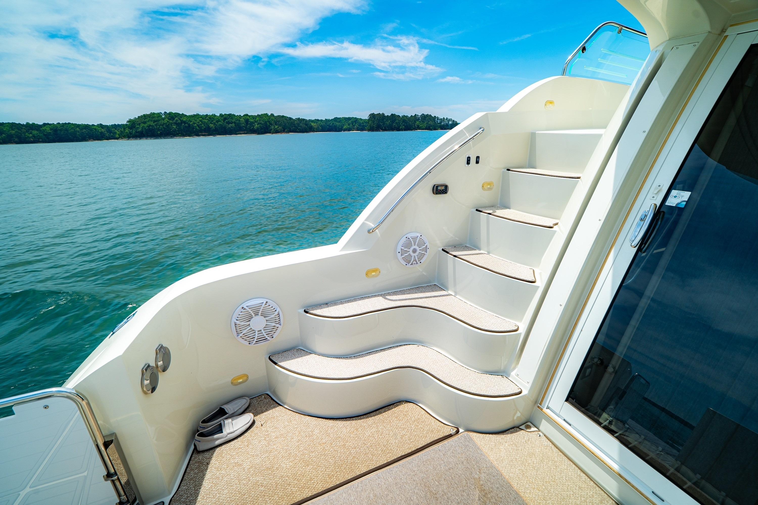 Staircase on 2011 Carver 44 Sojourn yacht with scenic lake view.