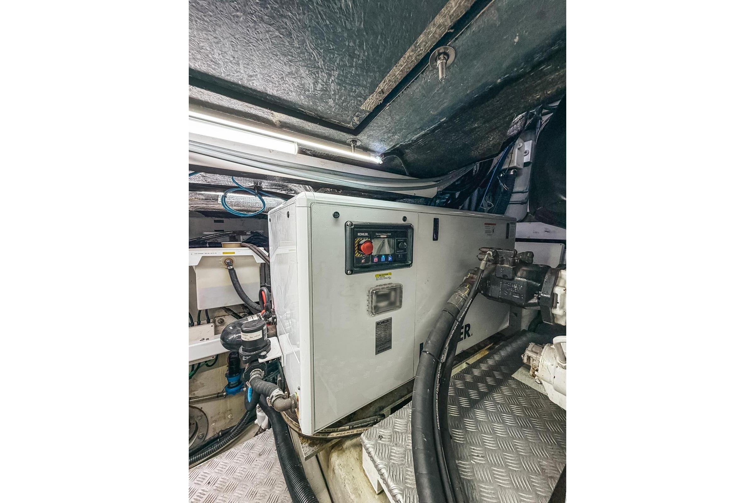 Engine room of 2010 Sunseeker Predator 84 yacht, featuring machinery and cables.