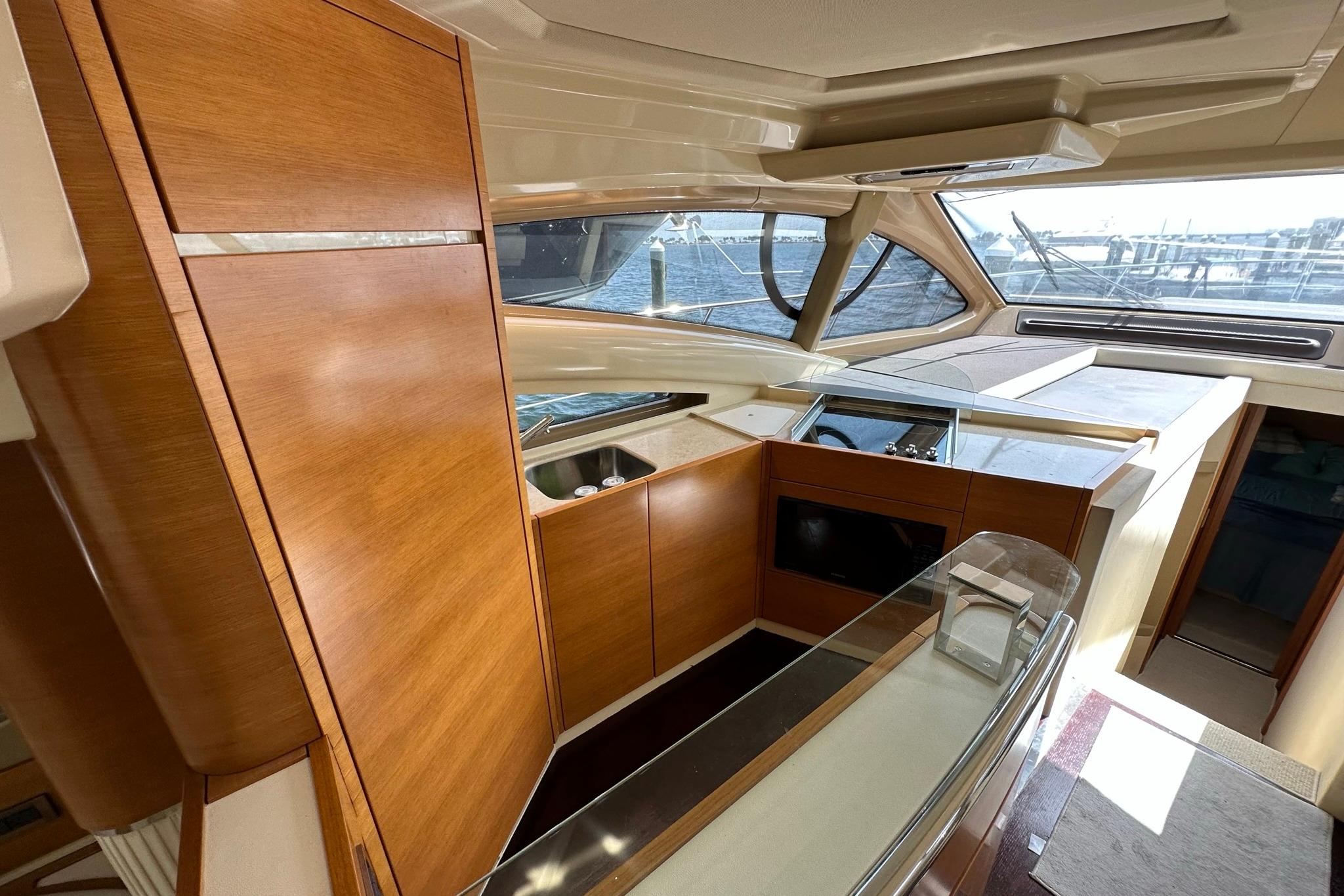 Luxurious interior of 2013 Azimut Fly 53 yacht with wooden cabinetry and panoramic windows.