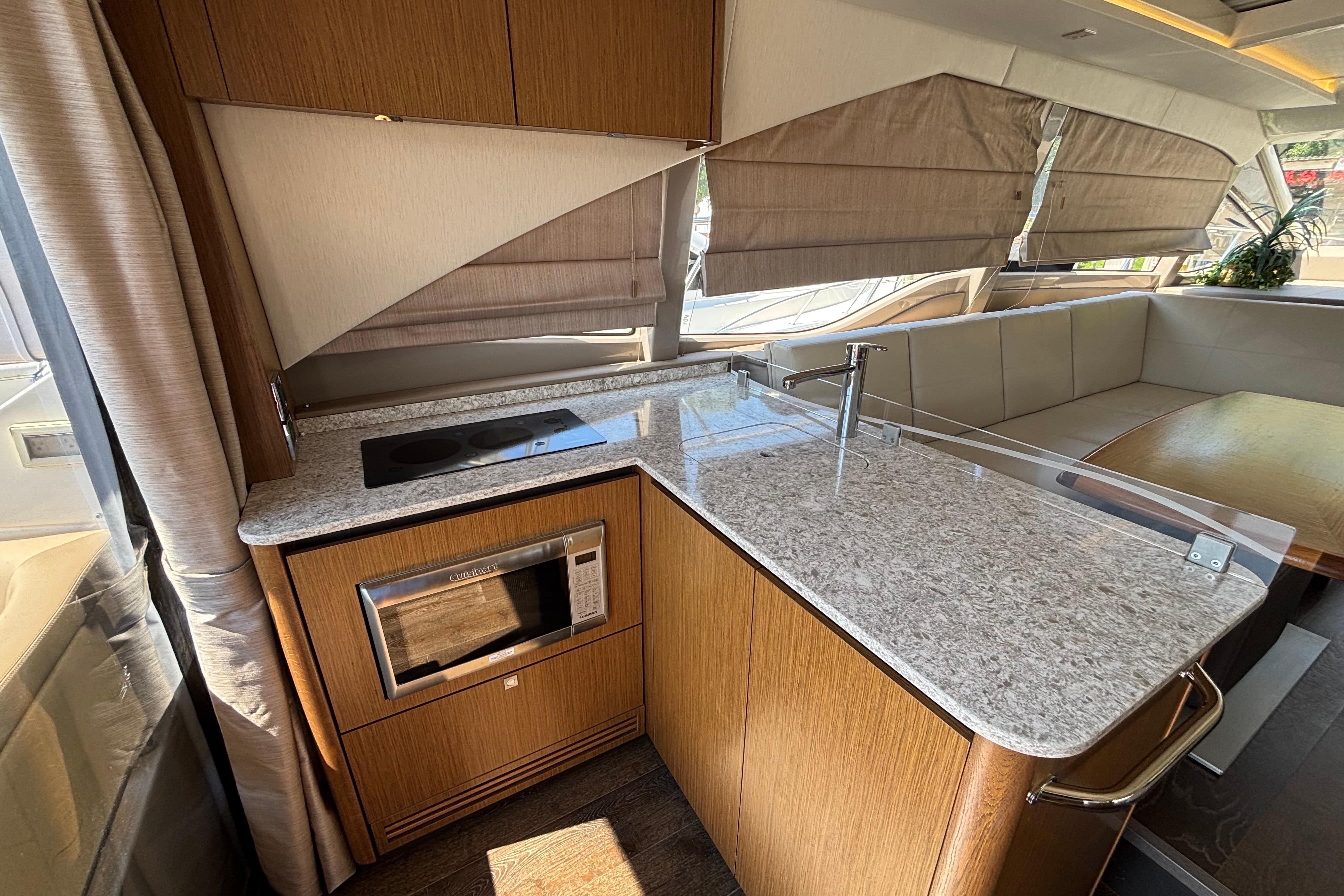 Luxurious 2018 Sea Ray Sundancer 460 yacht interior with modern kitchen and seating area.