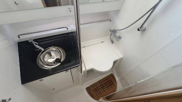Compact bathroom in 2025 Nimbus T11 boat with sink, toilet, and shower.