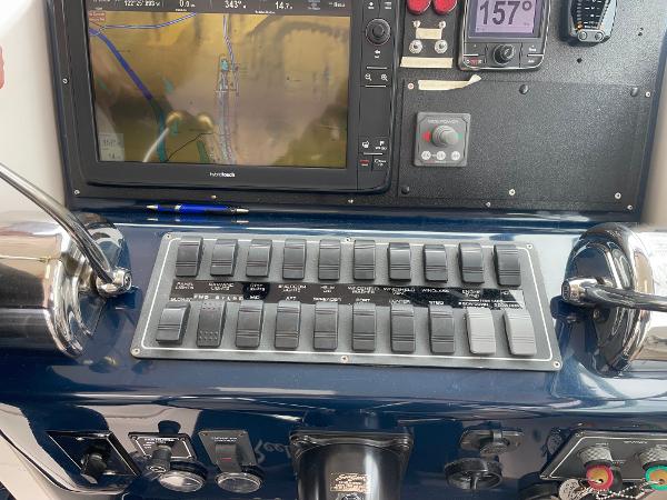 Control panel of a 2003 Tiara Yachts 3500 Open with navigation display and switches.