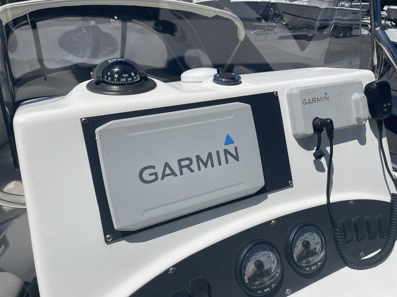 2006 Boston Whaler 210 Outrage dashboard with Garmin navigation system and compass.
