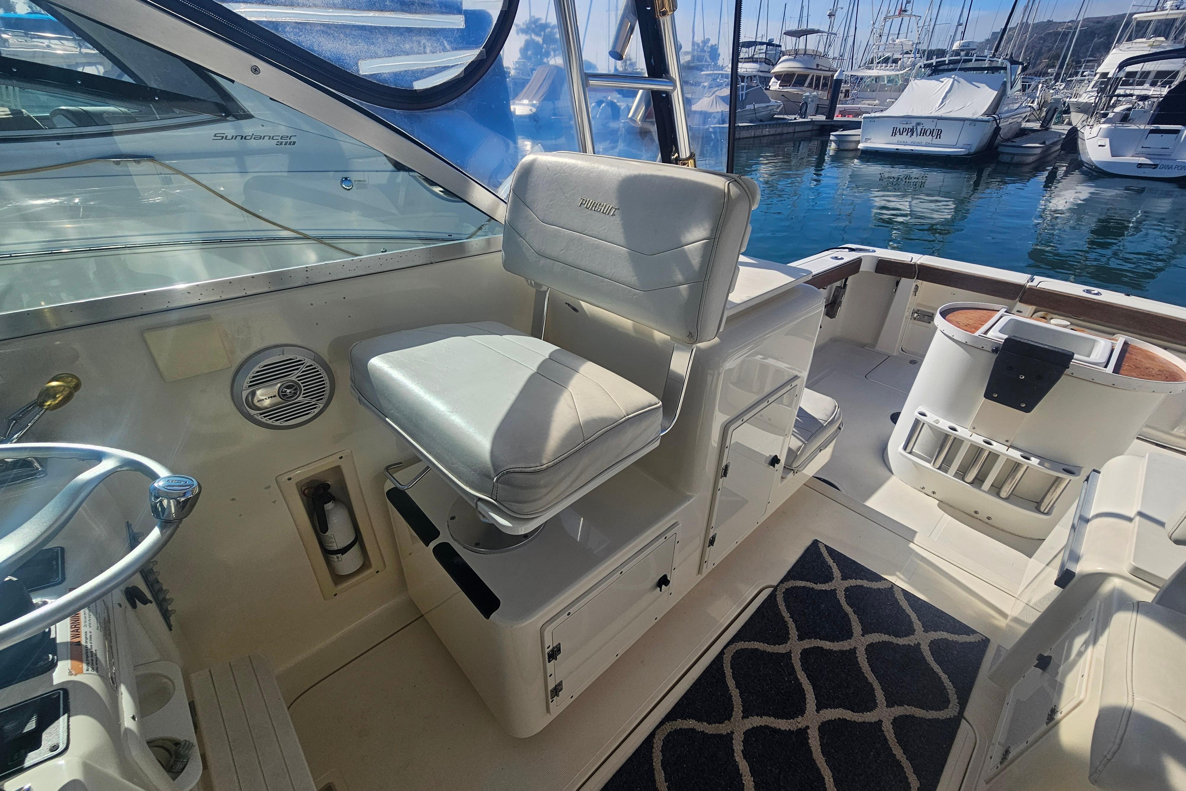 2001 Pursuit 3000 Express boat interior with helm seat and marina view.