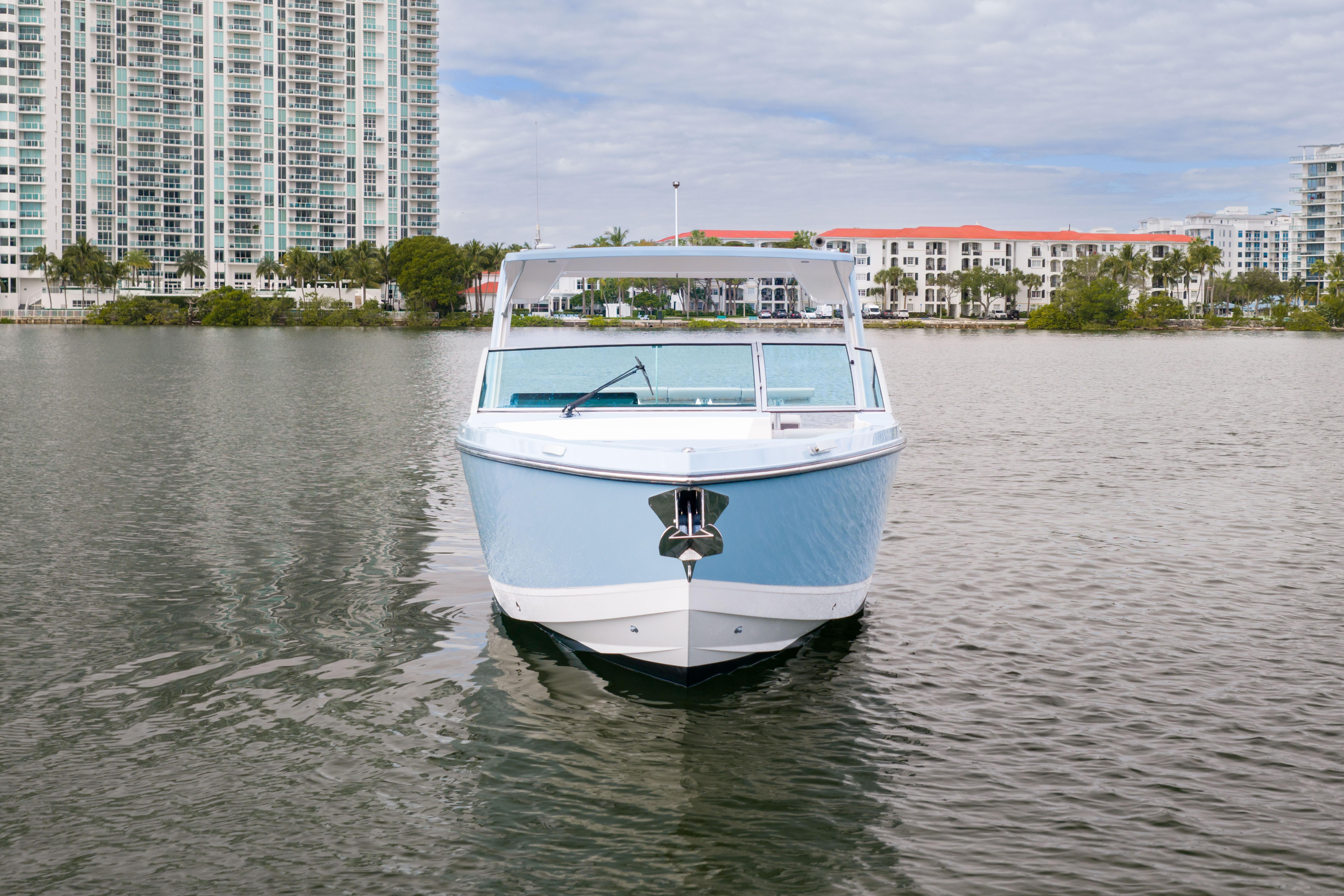 2022 Aviara AV32 OB boat on water with cityscape background.