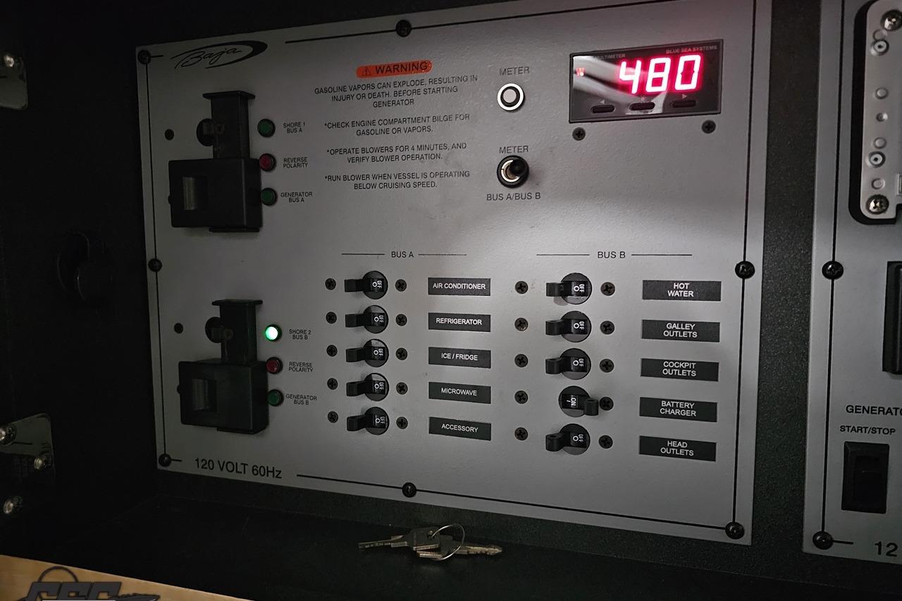 Control panel of a 2008 Baja 335 Performance boat with switches and digital display.