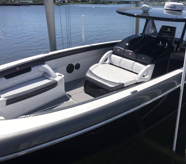 2017 Mystic Powerboats M4200 with luxurious seating on calm waters.