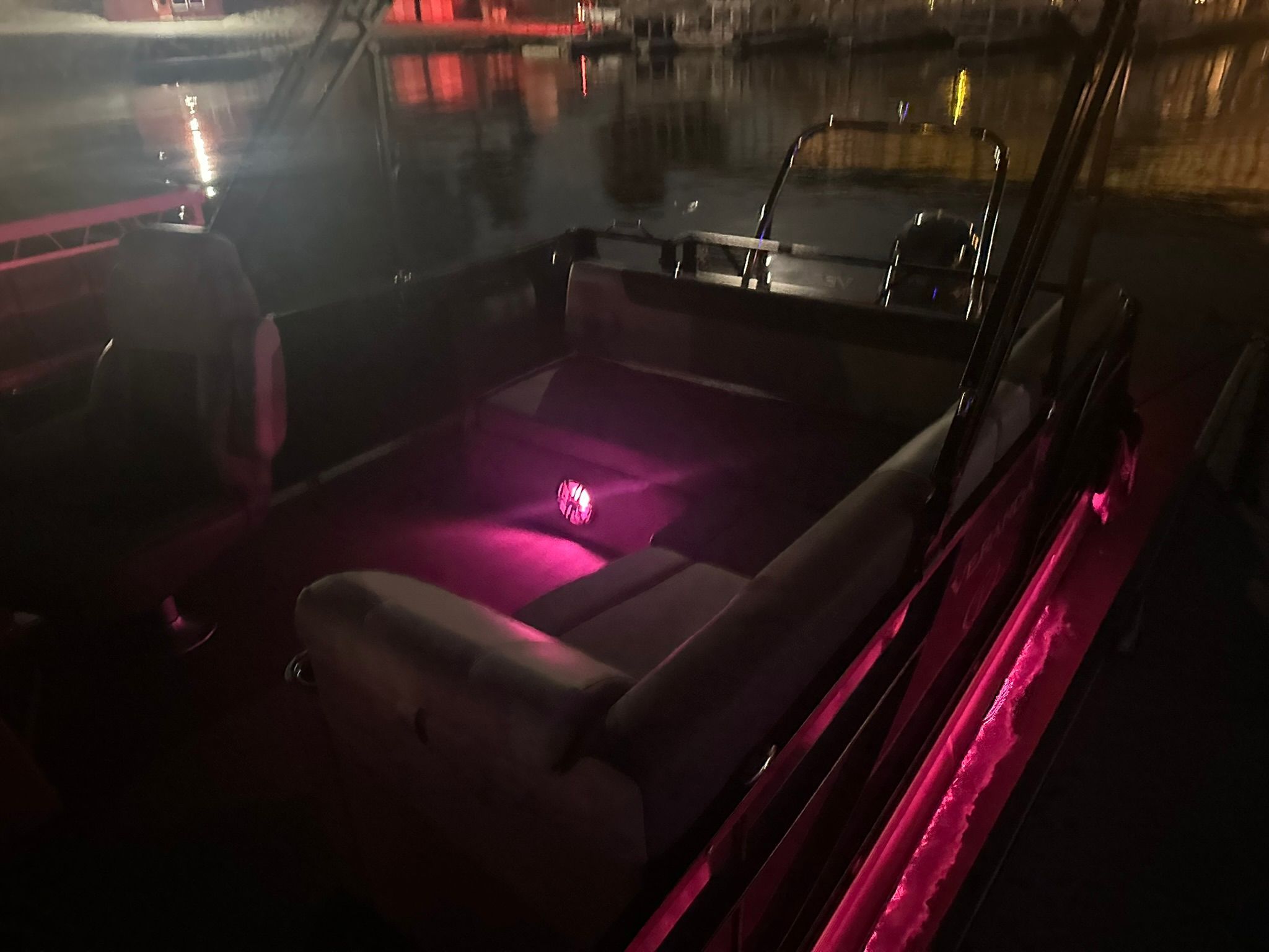 2023 Veranda Relax VR25VLB boat with ambient lighting at night.