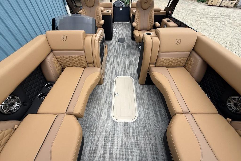 Luxurious interior of 2026 Godfrey Monaco 235 SFLC iMPACT pontoon boat with tan seating.