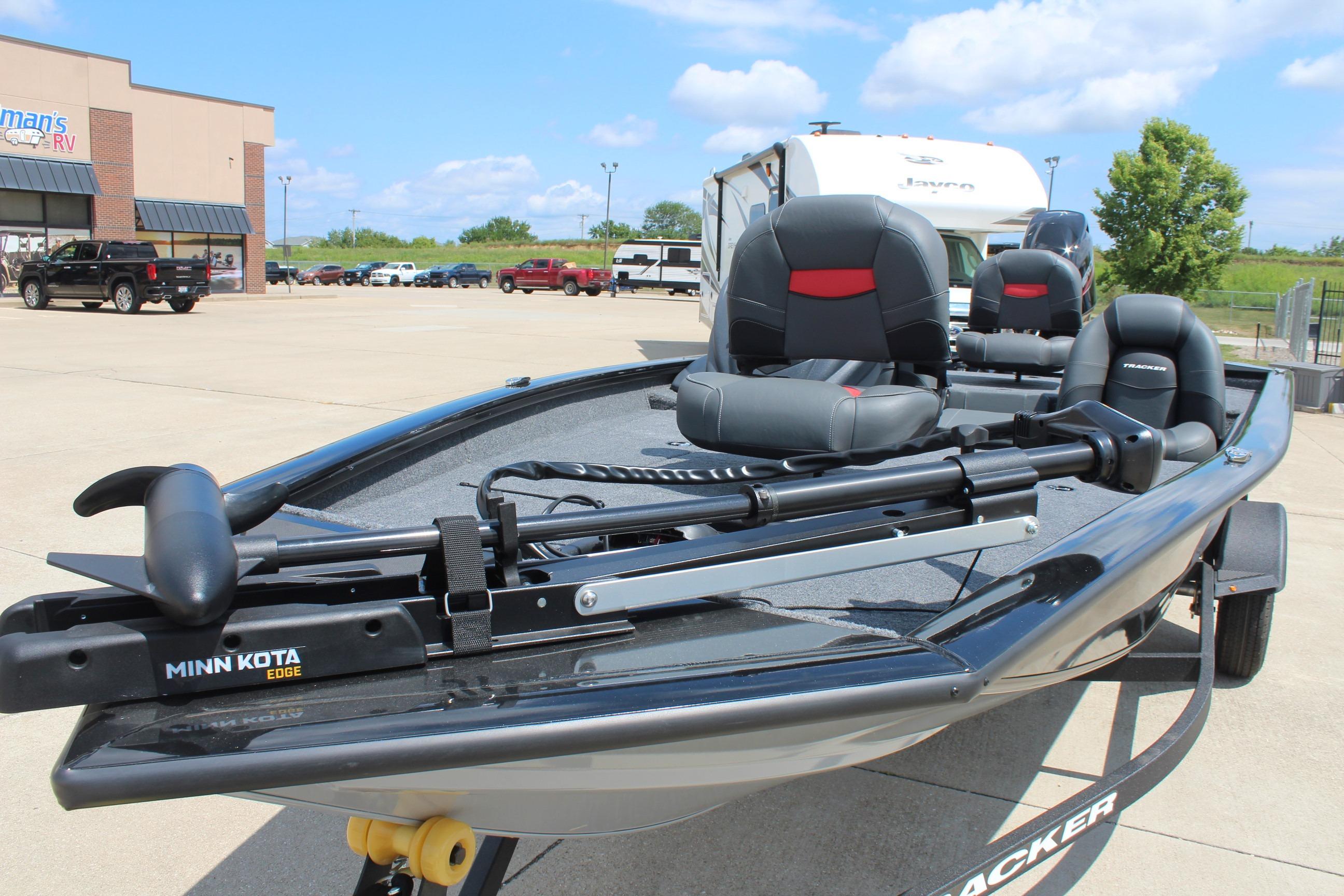 2026 Tracker Pro Team 175 boat with Minn Kota Edge motor in parking lot.
