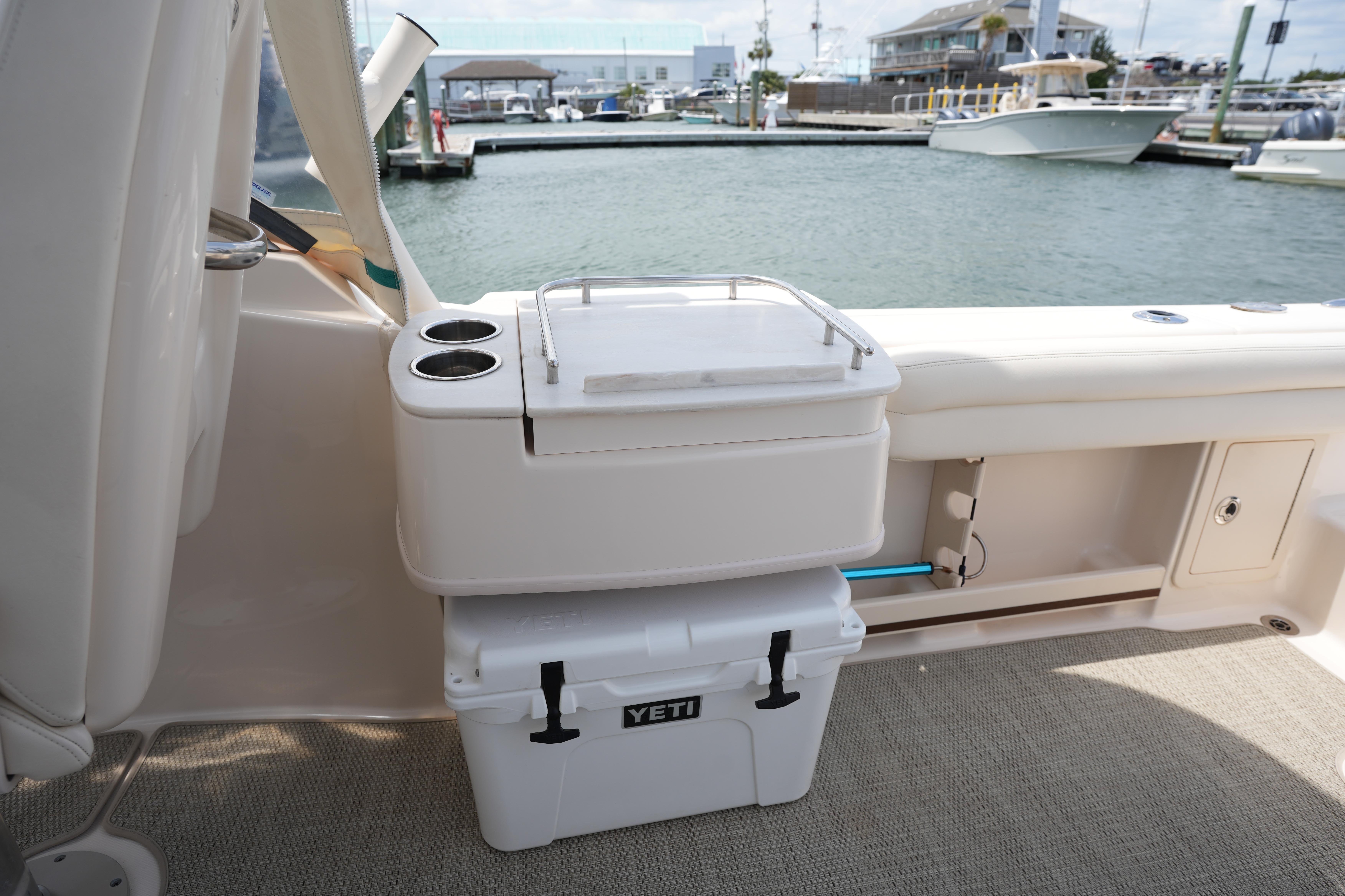 2021 Grady-White Freedom 235 boat interior with Yeti cooler and cup holders at marina.