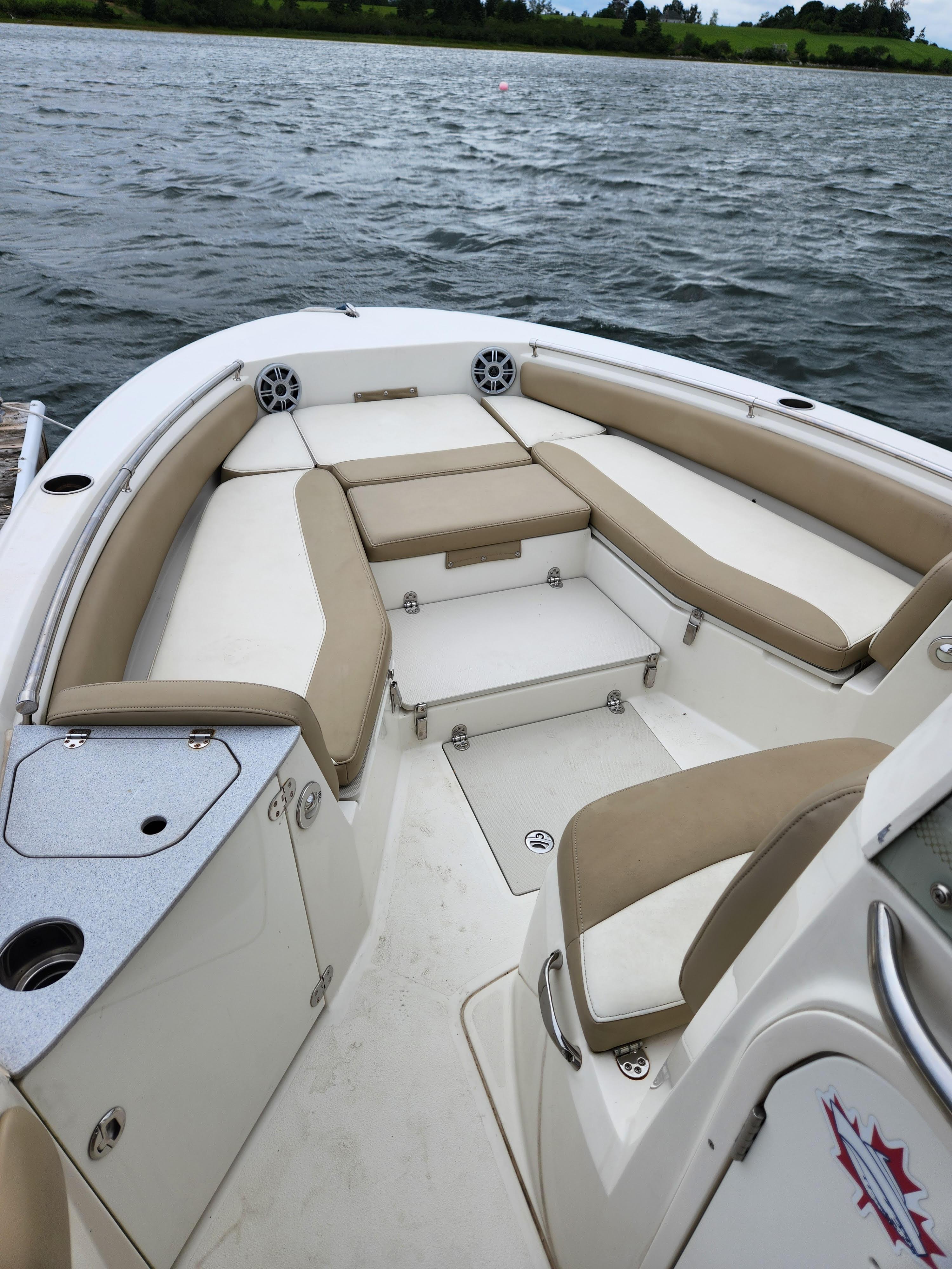 2018 Stingray 236 CC boat with beige seating on a lake.