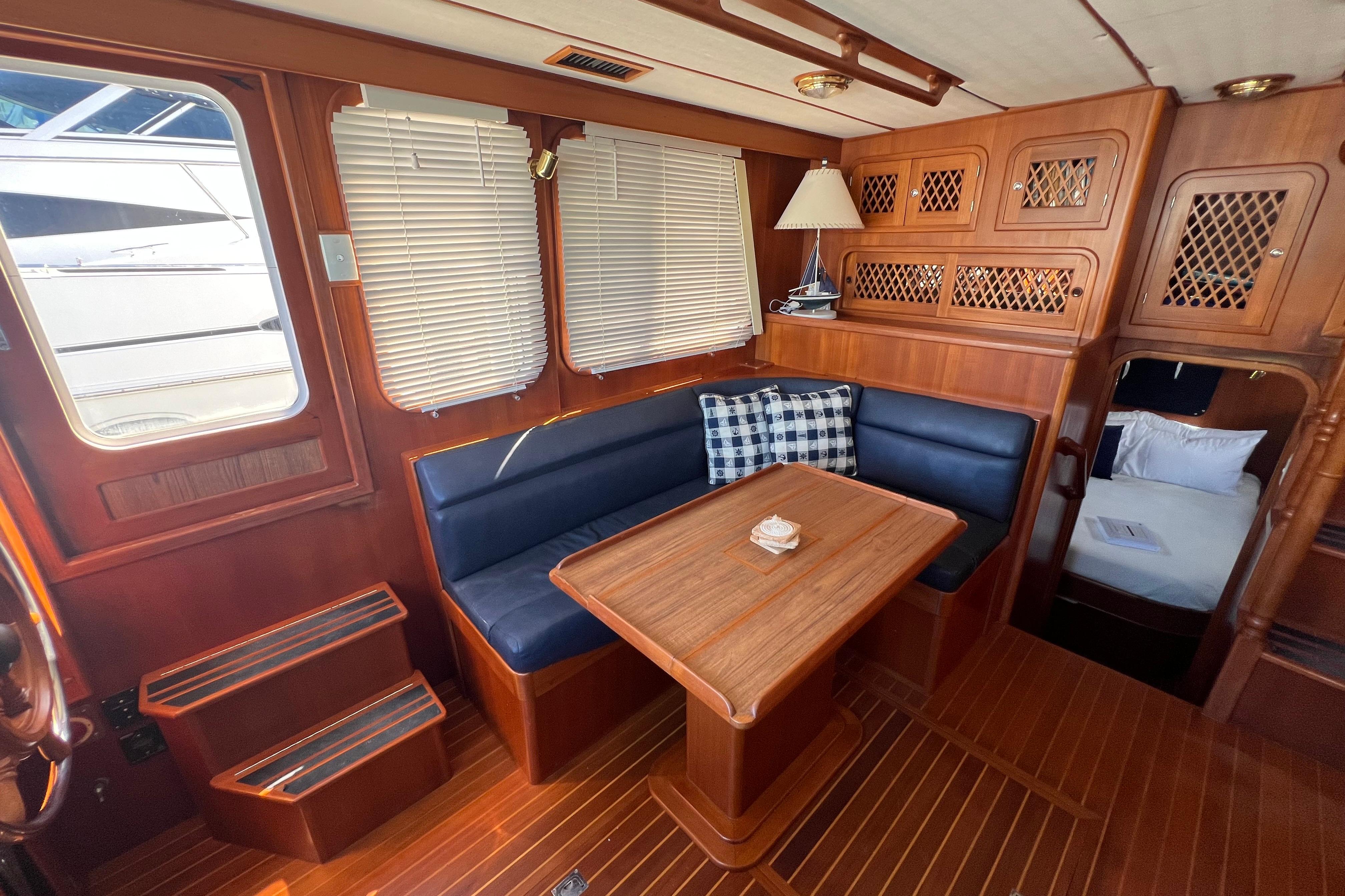 Interior of 2007 Heritage East 36 Sundeck Trawler with wood finish and cozy seating area.