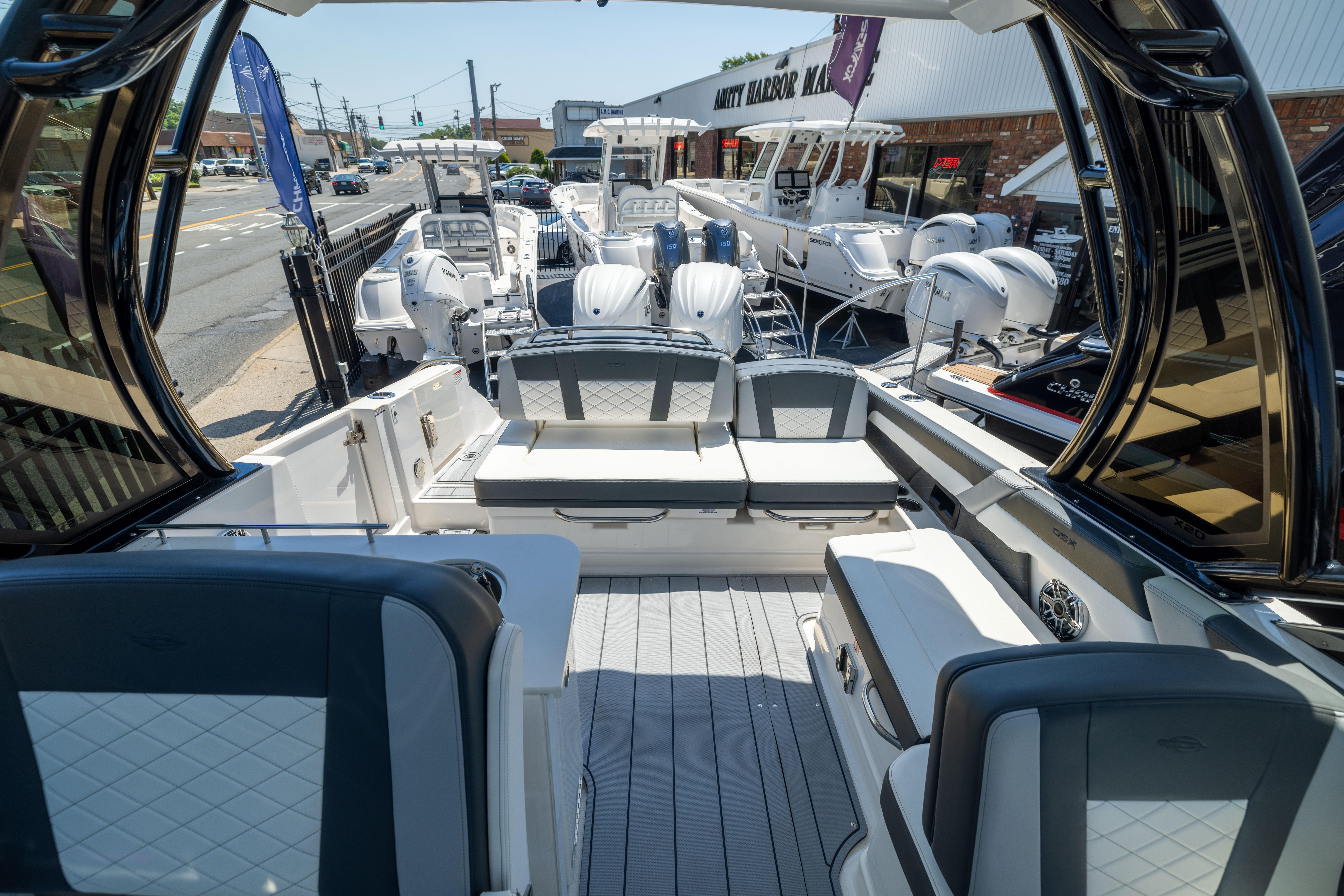 2026 Chaparral 310 OSX boat interior with luxurious seating at a marina display.