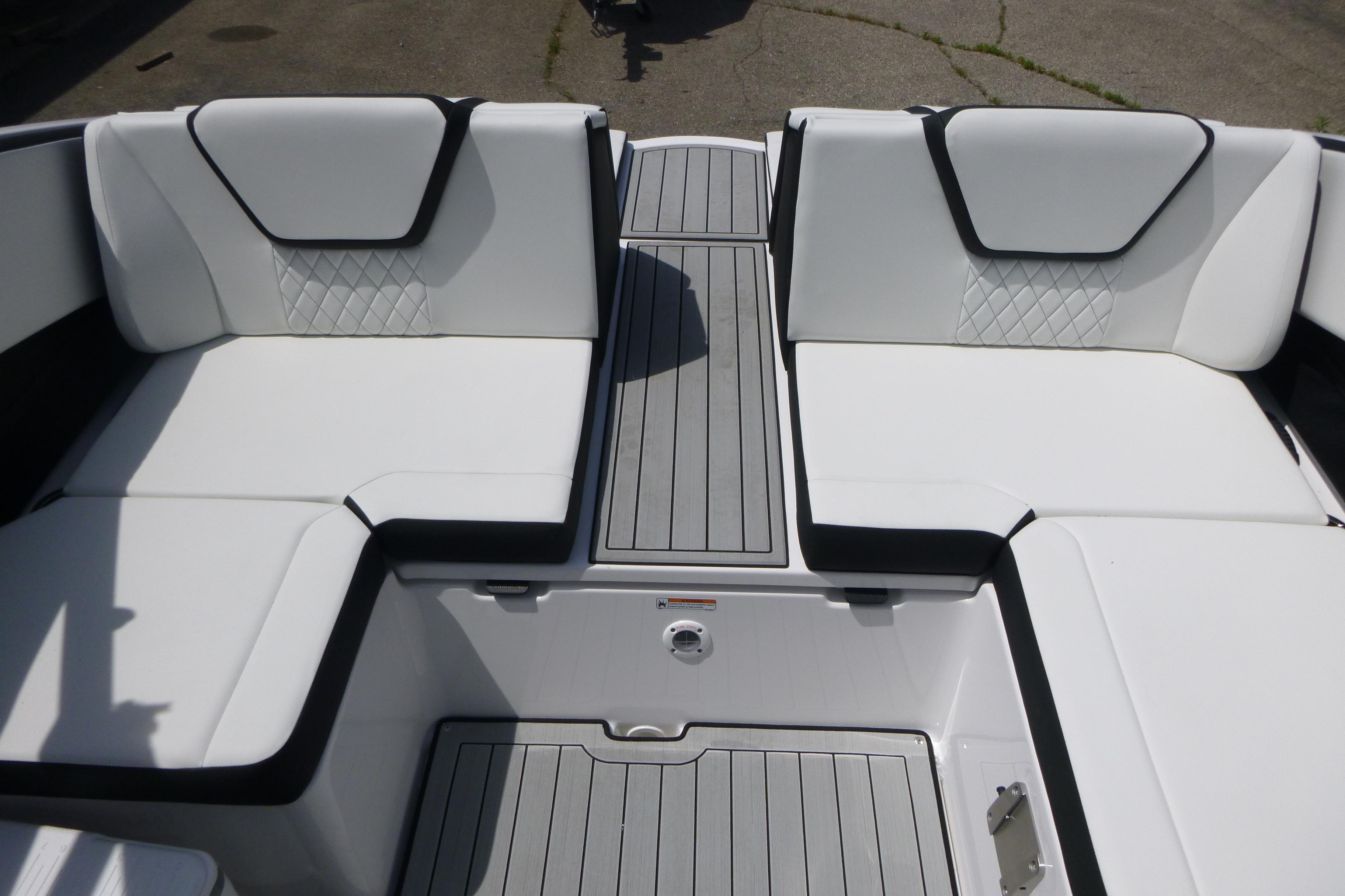 2026 Yamaha Boats 222S interior with white cushioned seating and sleek gray flooring.