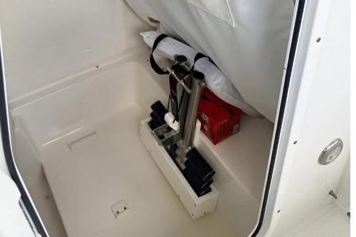 Storage compartment of 2023 Sea Hunt Ultra 239 SE boat, featuring organized equipment and accessories.