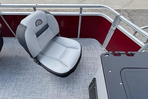 2026 Sun Tracker SportFish 20 DLX boat interior with gray seating and red paneling.