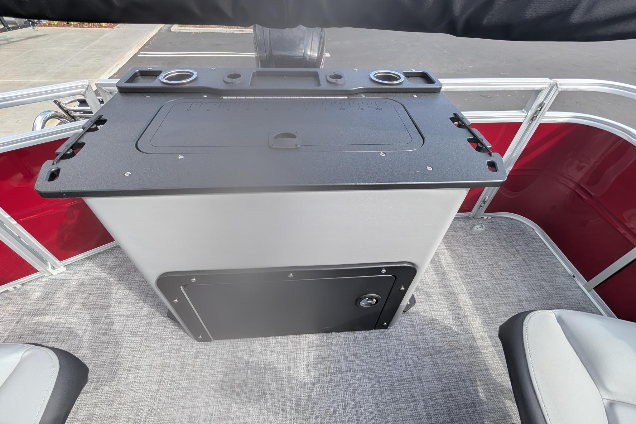 2026 Sun Tracker SportFish 20 DLX boat interior with fishing station and rod holders.