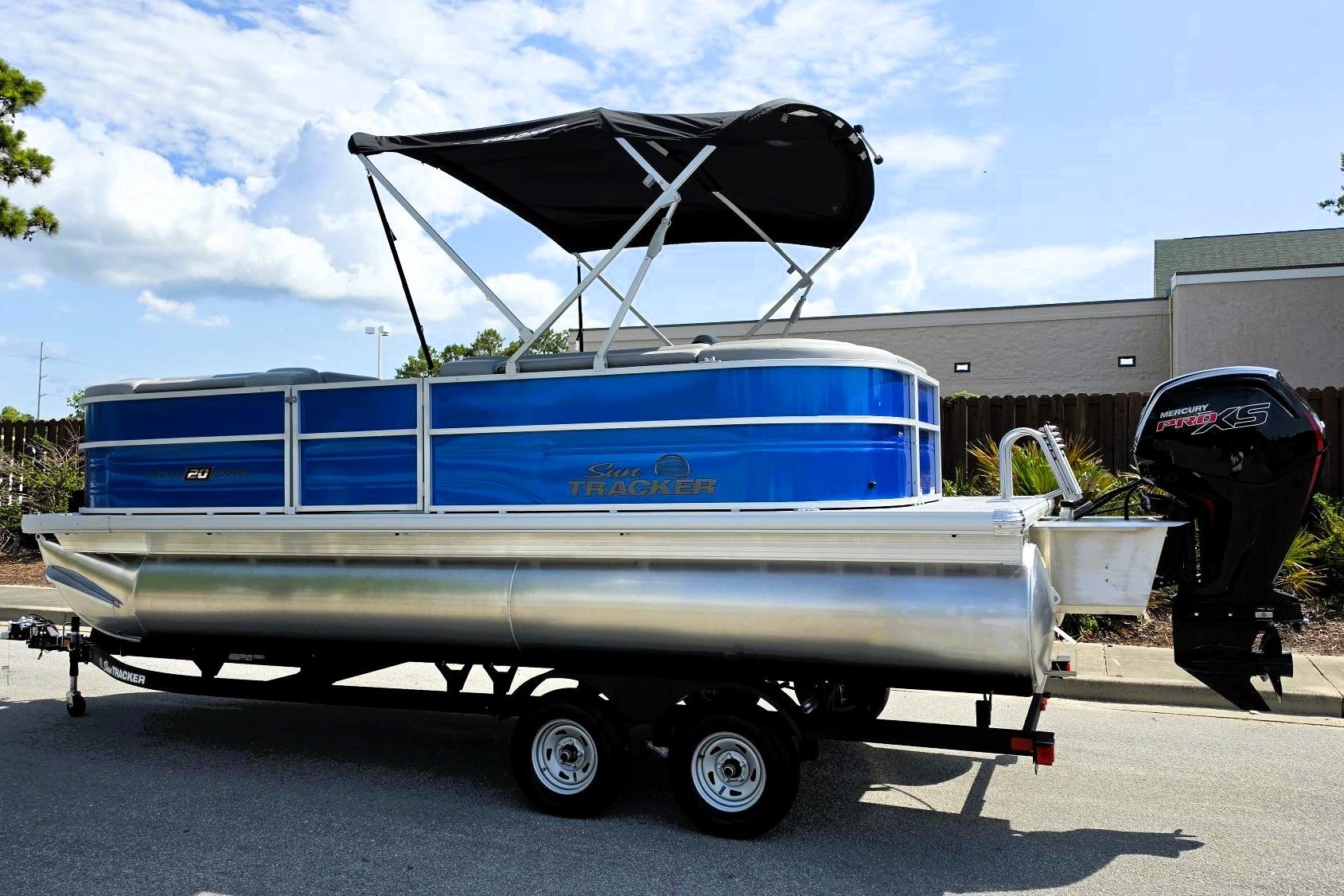 2026 Sun Tracker Party Barge 20 DLX pontoon boat with canopy and Mercury Pro XS engine.