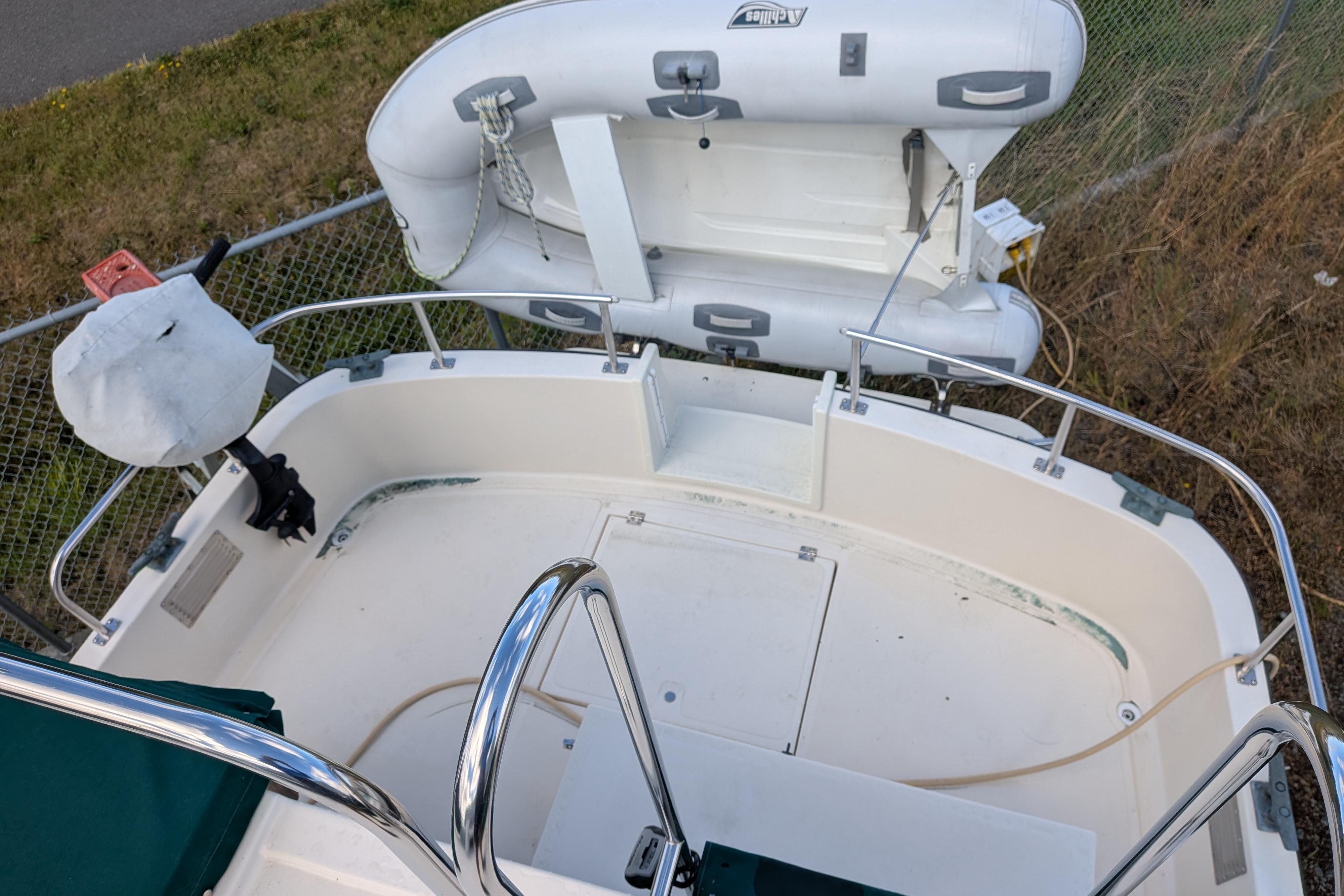 1998 Nordic Tug 32 boat deck with inflatable dinghy and railing.