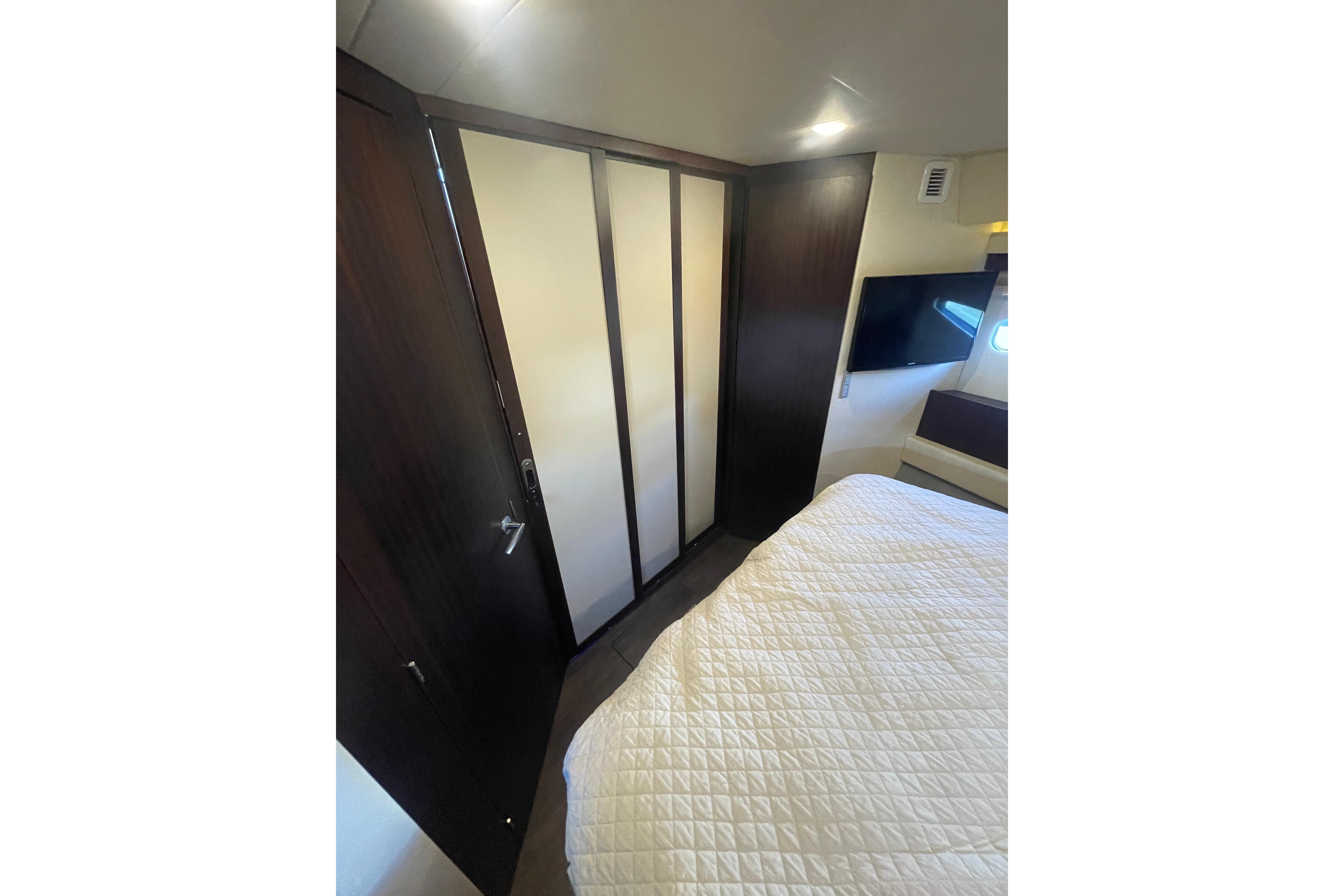 Interior cabin of 2020 Regal 42 Grande Coupe with modern design and cozy bedding.