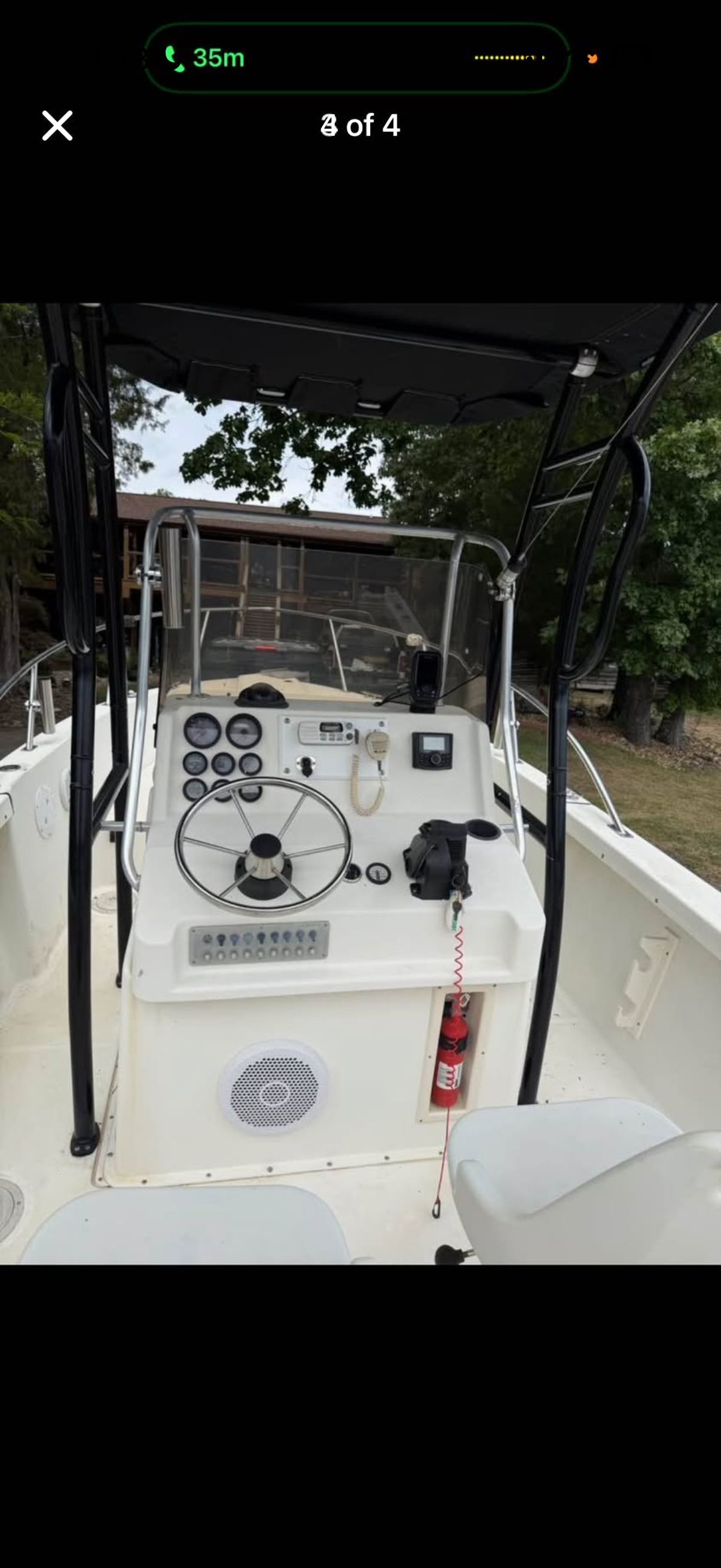 The image shows the cockpit of a 1996 Pursuit 2150 boat with controls and instruments.