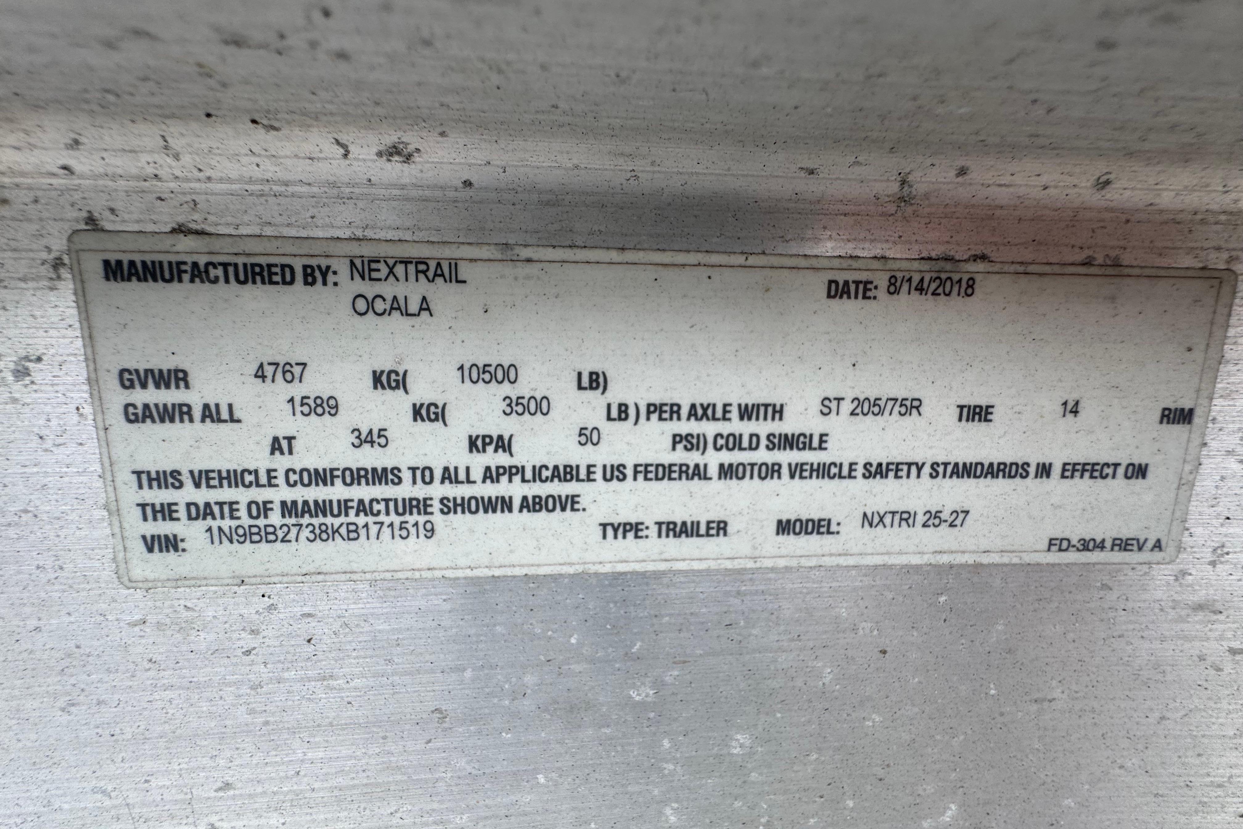 Label on trailer manufactured by Nextrail, Ocala, dated 8/14/2018, with specifications.