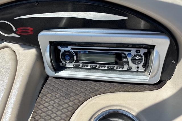 2012 Tahoe Q8 SSi boat dashboard with stereo system and cup holder.