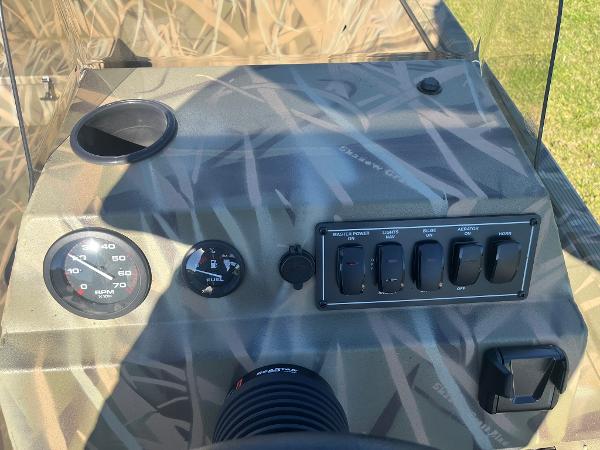 Control panel of 2025 Lowe Roughneck 2070 SC boat with gauges and switches.
